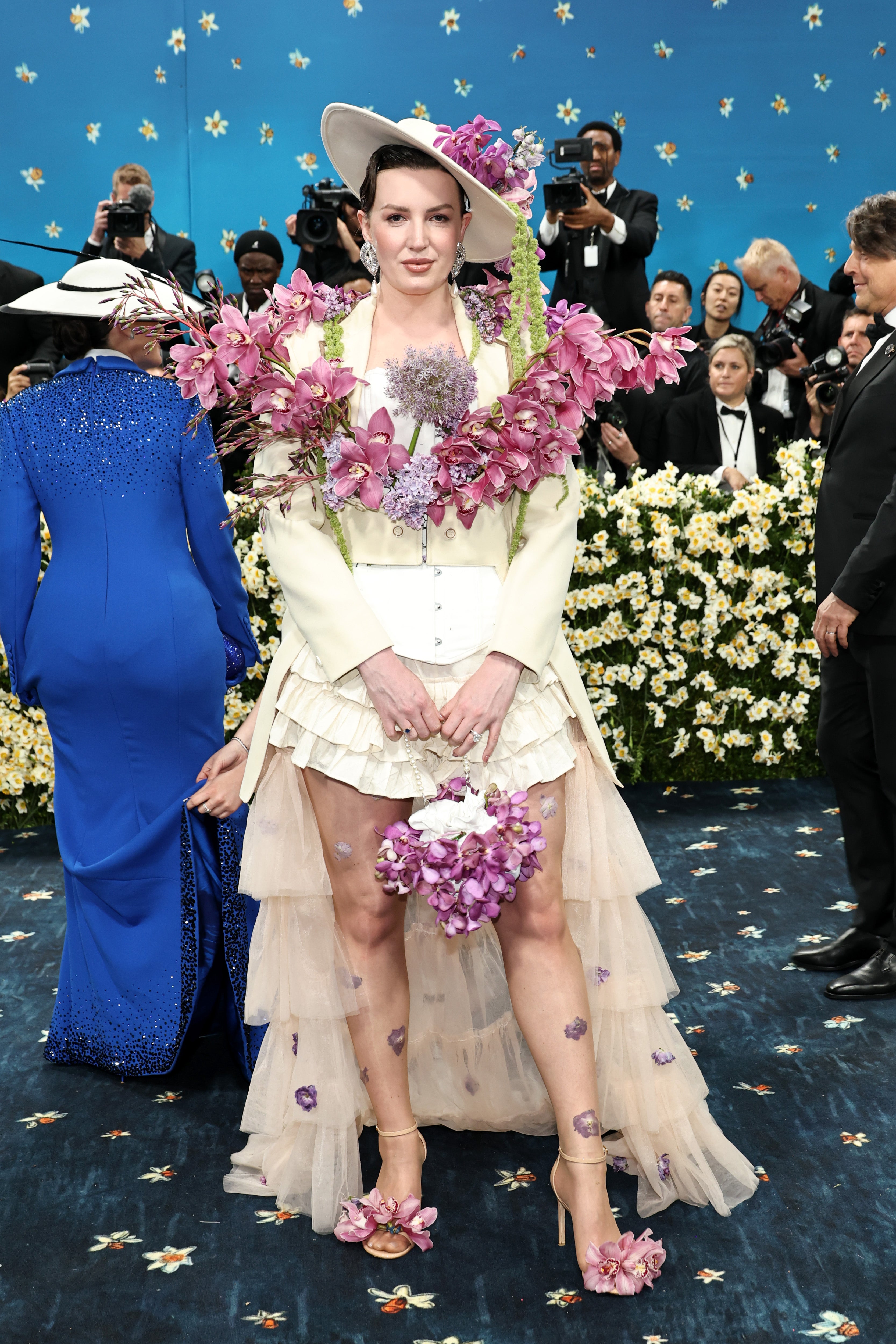 Jessica Kayll, a British fashion designer, posed for pictures on the Met Gala red carpet in a floral-embellished ensemble that can only be likened to Kentucky Derby Fashion