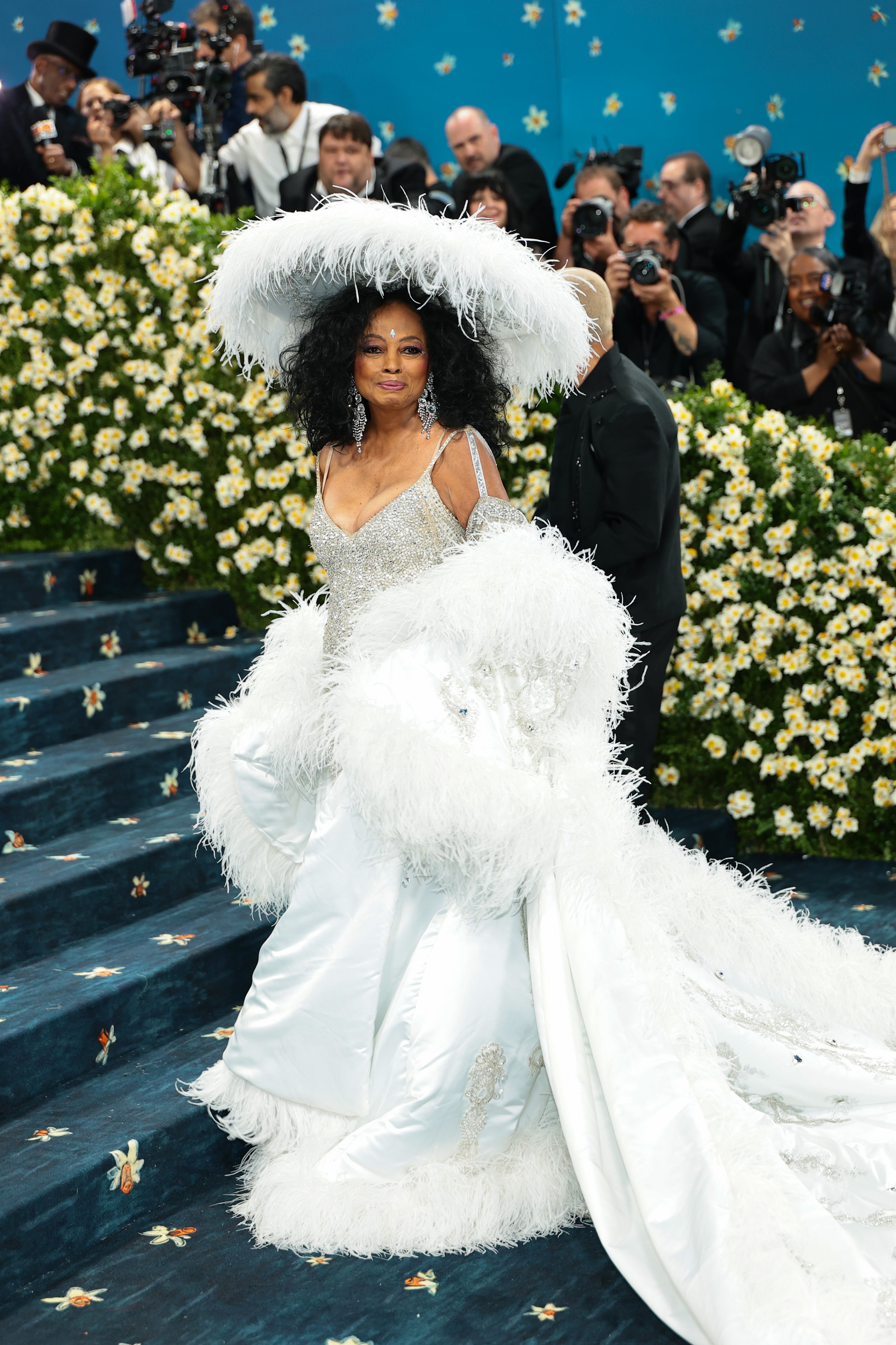 Diana Ross stunned in a silver dress with a satin white feather, skirt, paired with a matching feather train