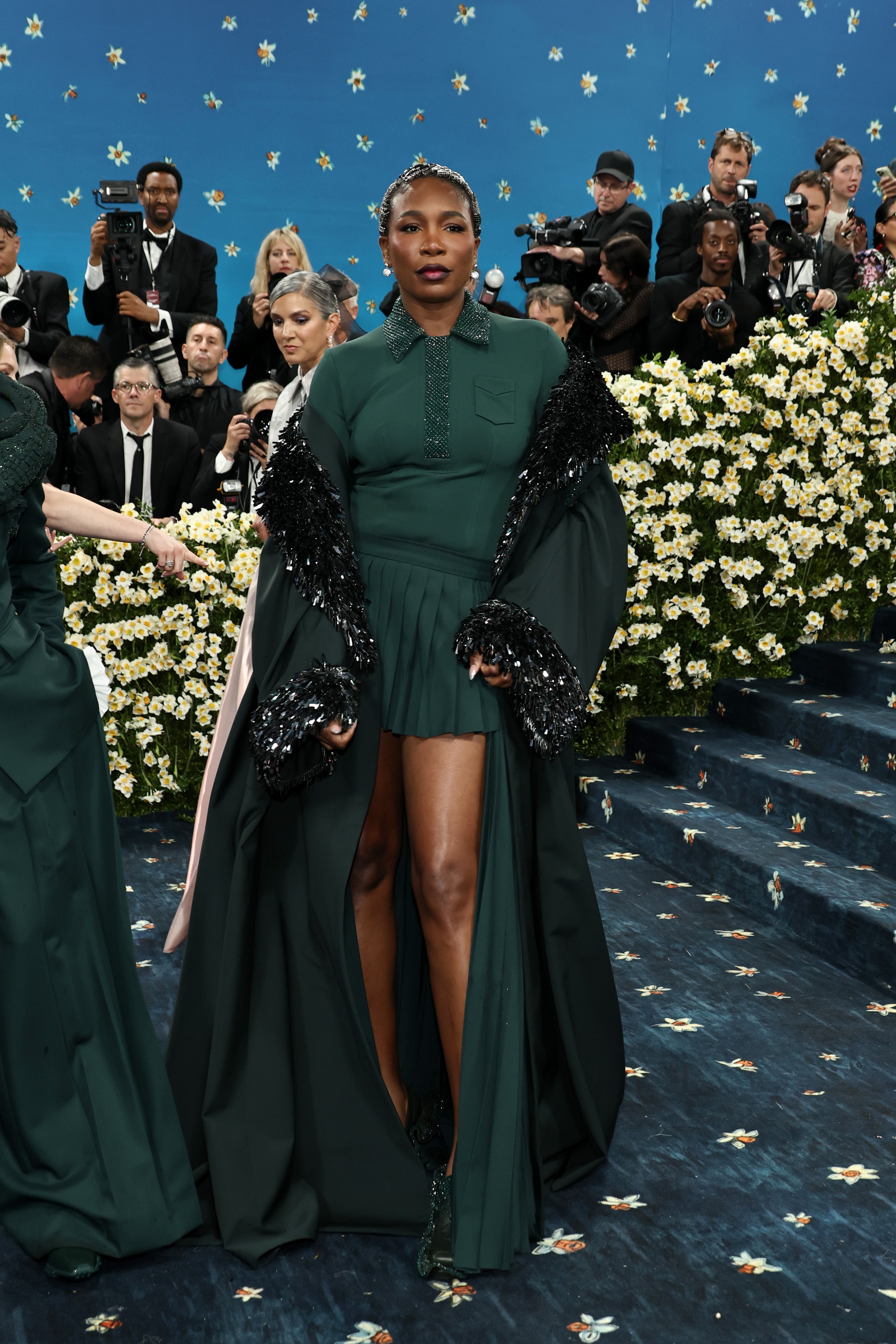 Venus Williams posed for the many cameras on the Met steps in a forest green collared shirt and skirt set akin to her standard tennis fashion