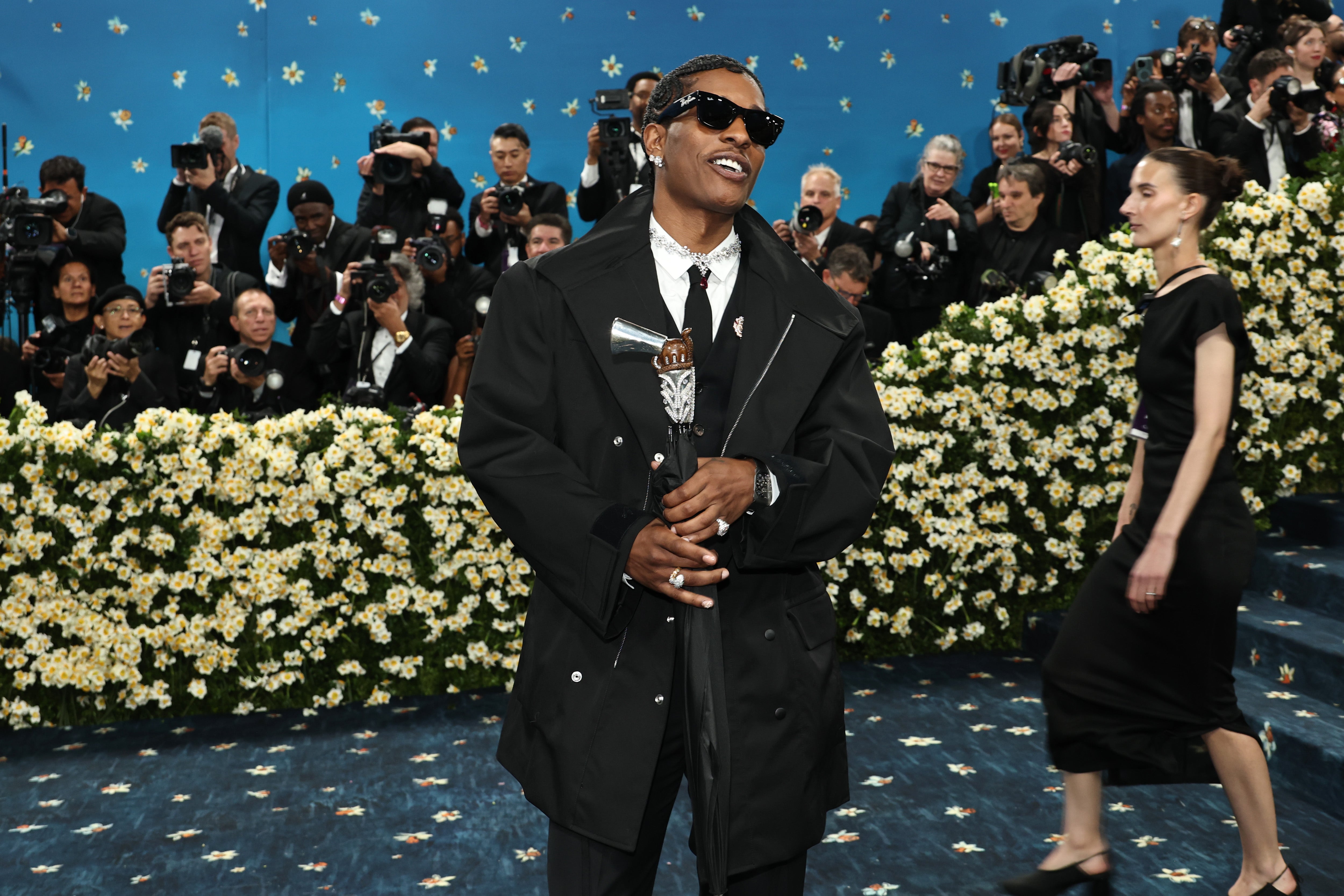 A$AP Rocky attends the 2025 Met Gala with a diamond-encrusted umbrella shaped like a gun