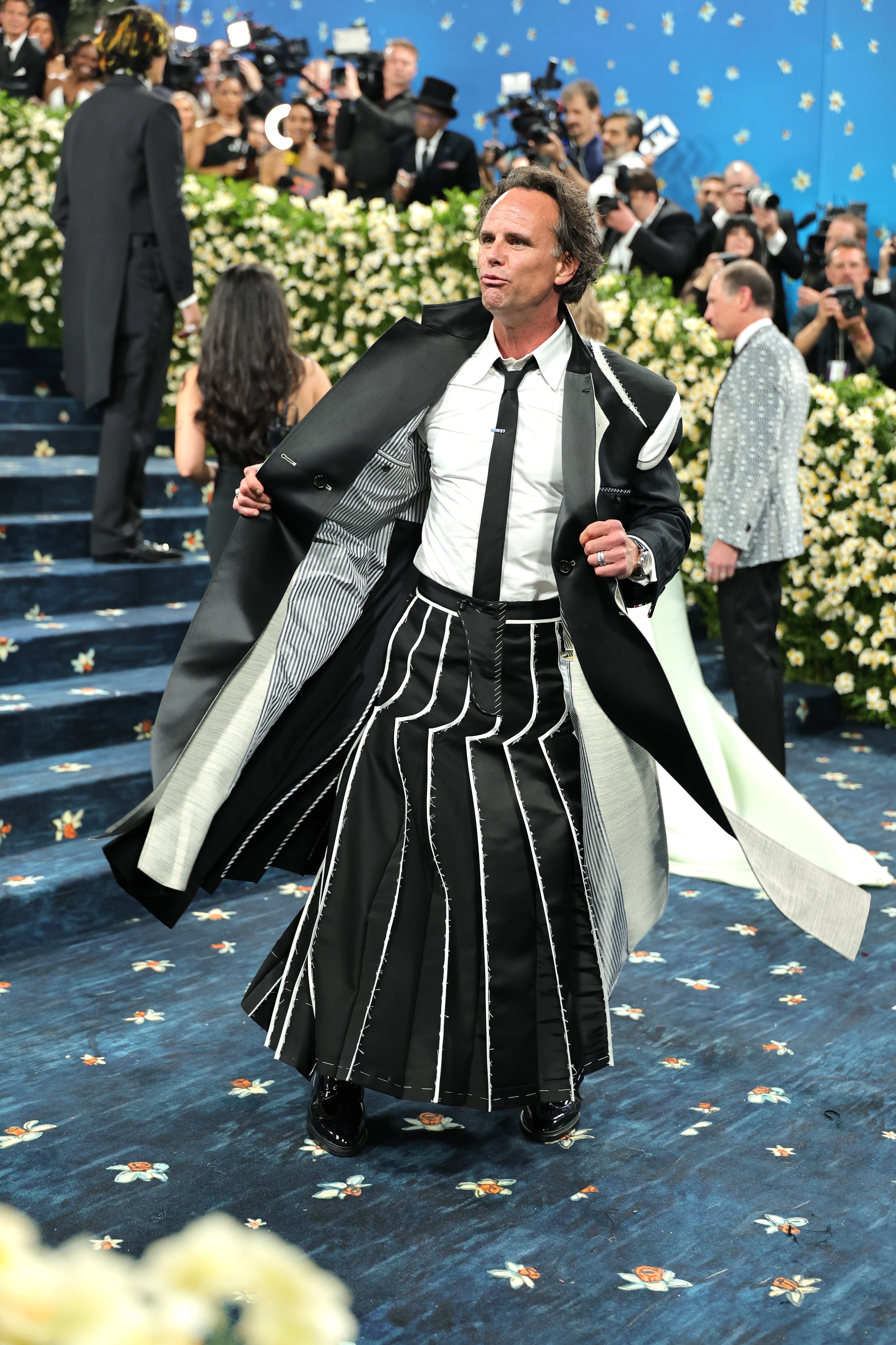 Walton Goggins, who starred in season three of ‘The White Lotus’, wore a black skirt with white stripes and a matching, long jacket, designed by Thom Browne. He also opted for a white shirt and black tie