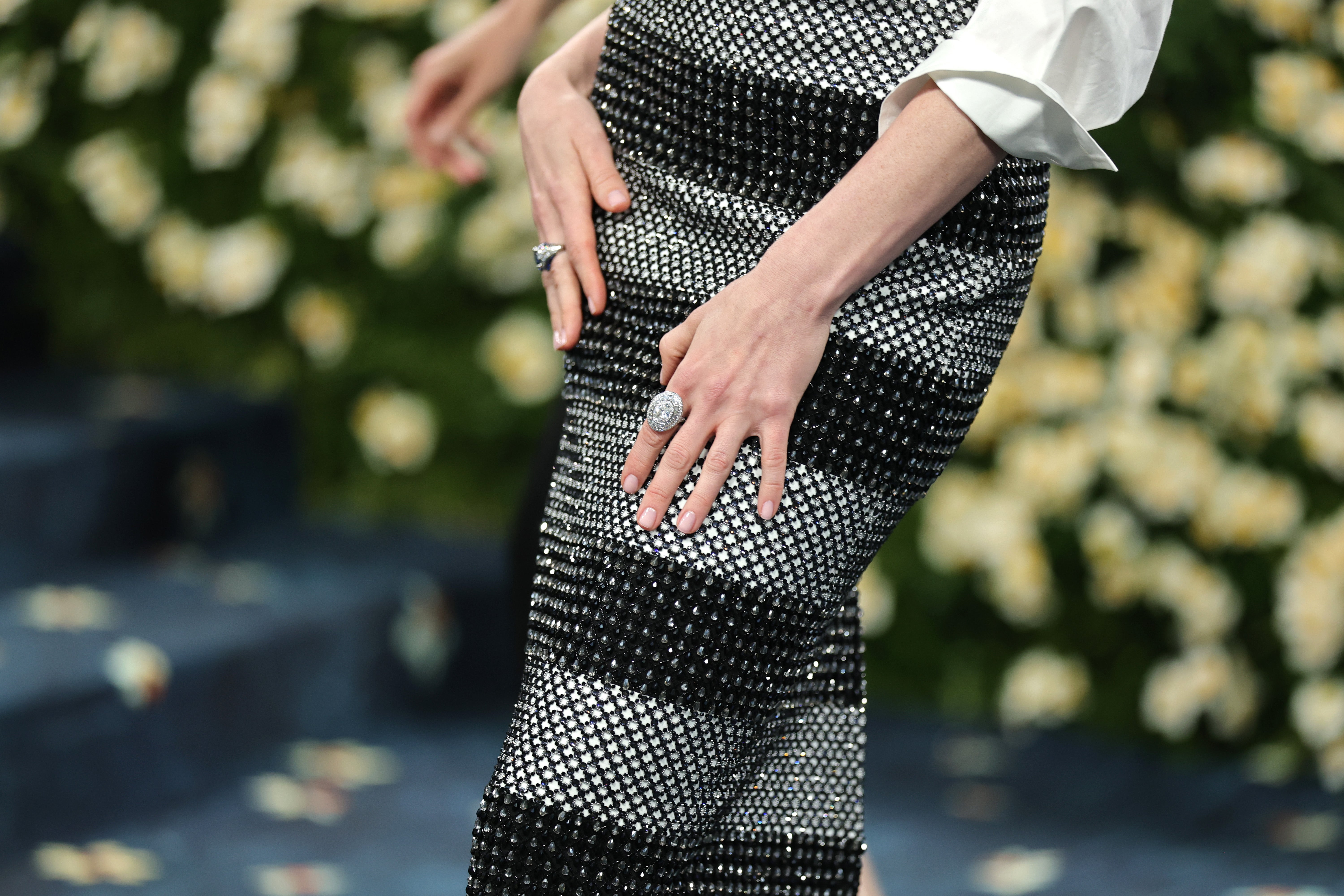 The actor tucked her blouse into a netted black and white striped skirt