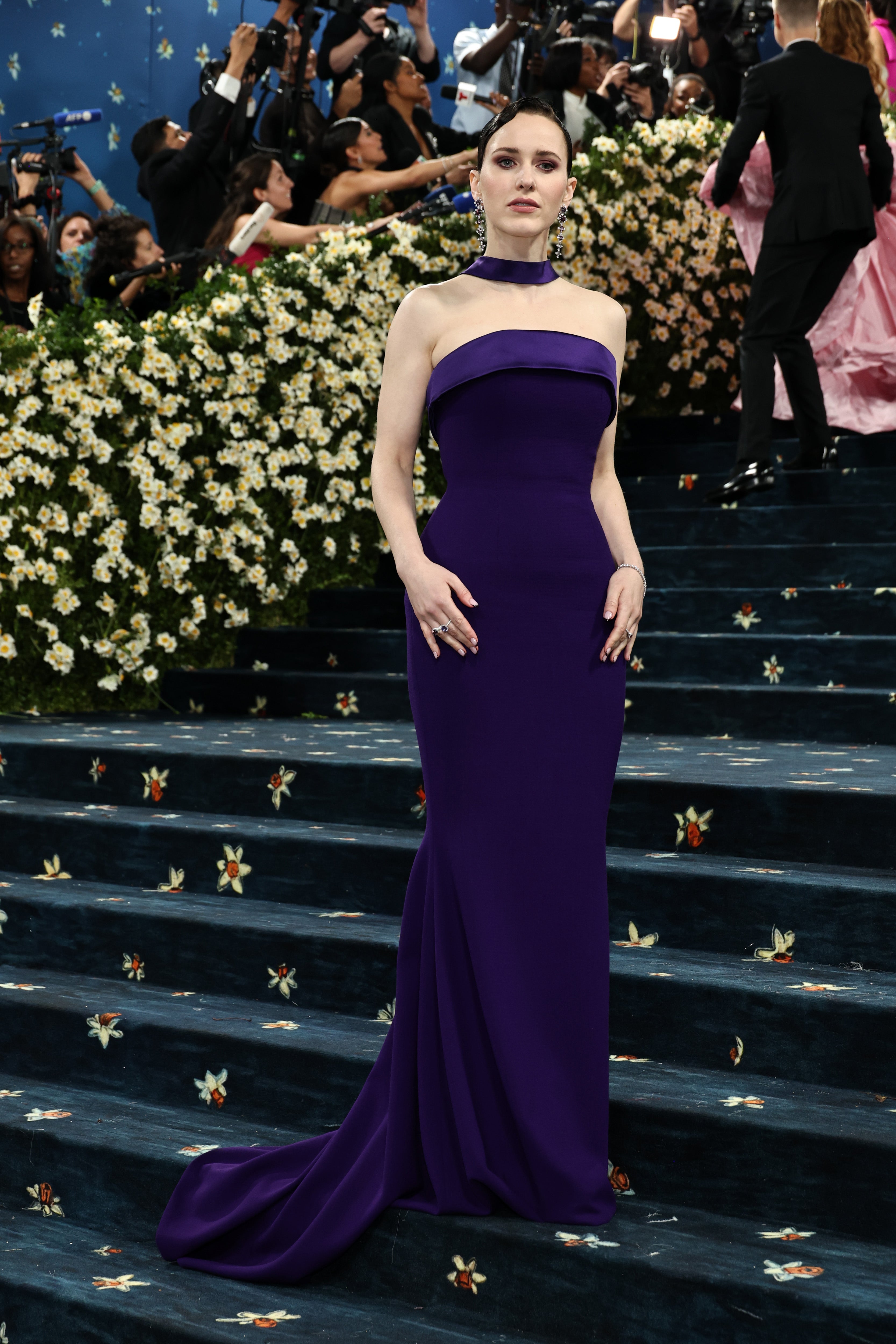 Actor Rachel Brosnahan posed for the cameras outside the Met on Monday in a simple purple gown that didn’t seem to do much to honor the theme, ‘Superfine: Tailoring Black Style’