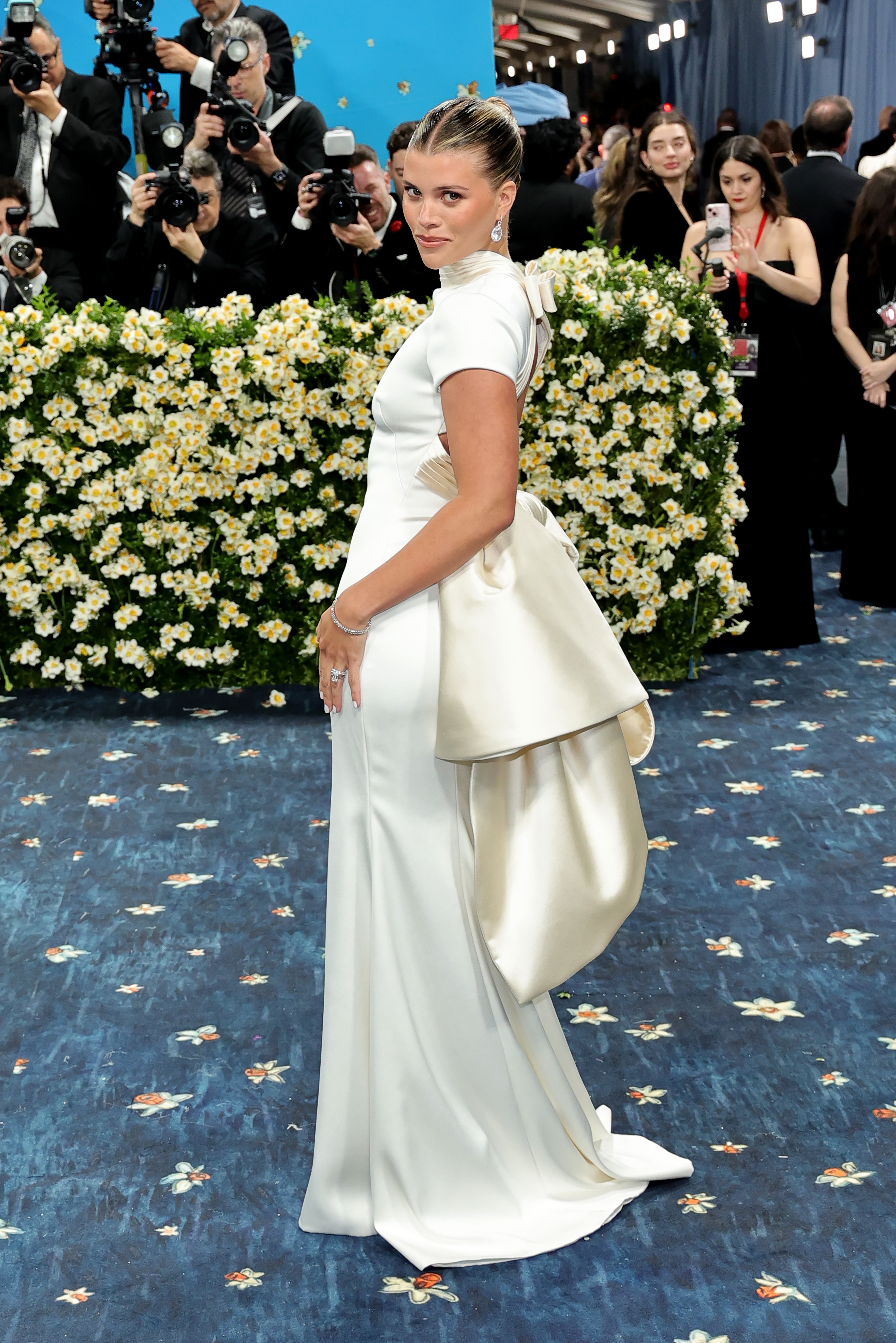 Sofia Richie dressed in an ultra-feminine white and ivory gown for the 2025 Met Gala centered around Black dandyism and menswear