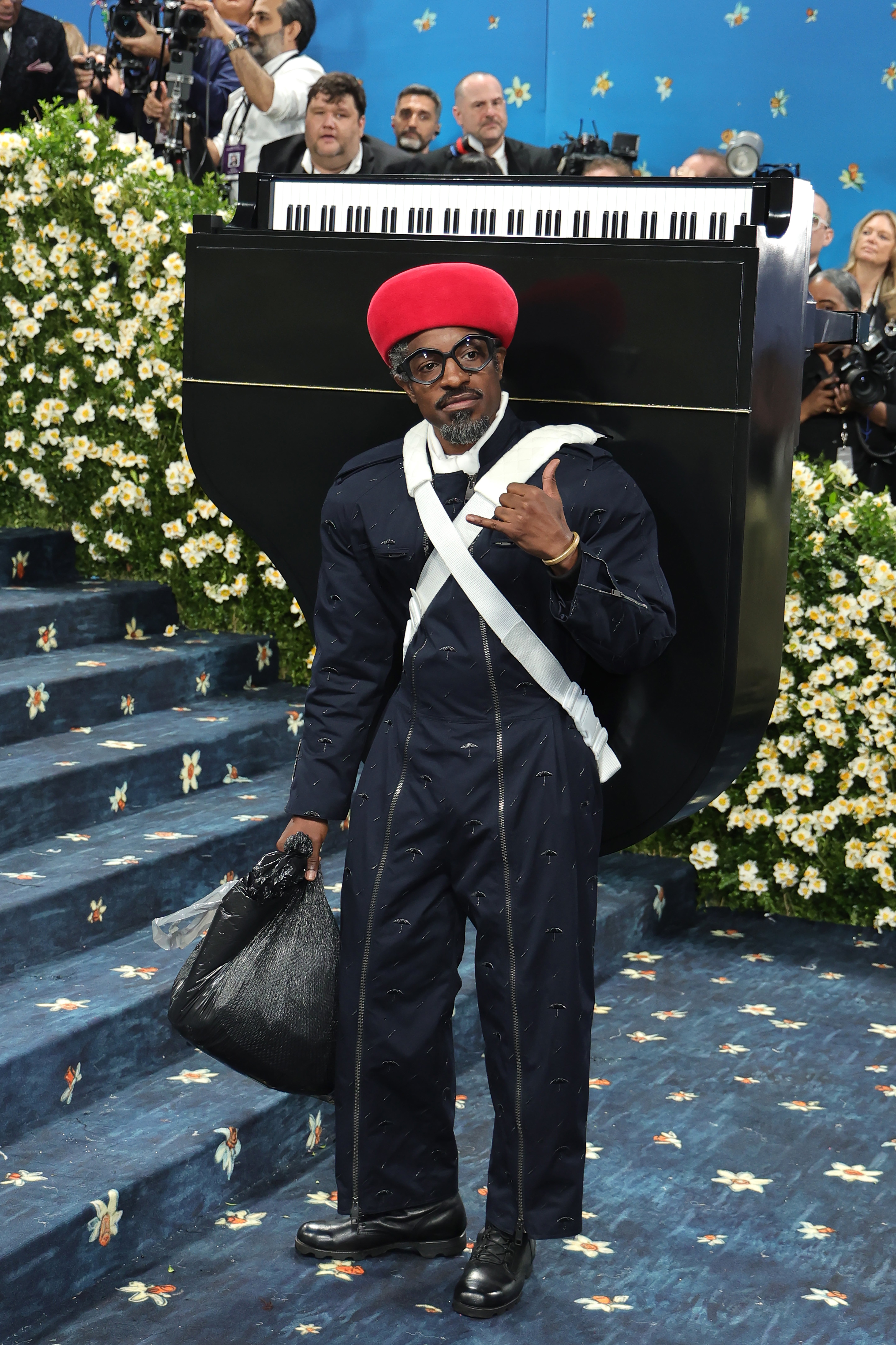 André 3000 hauled a miniature piano on his back and took out the trash as he walked the steps of the Met for the annual gala on Monday night