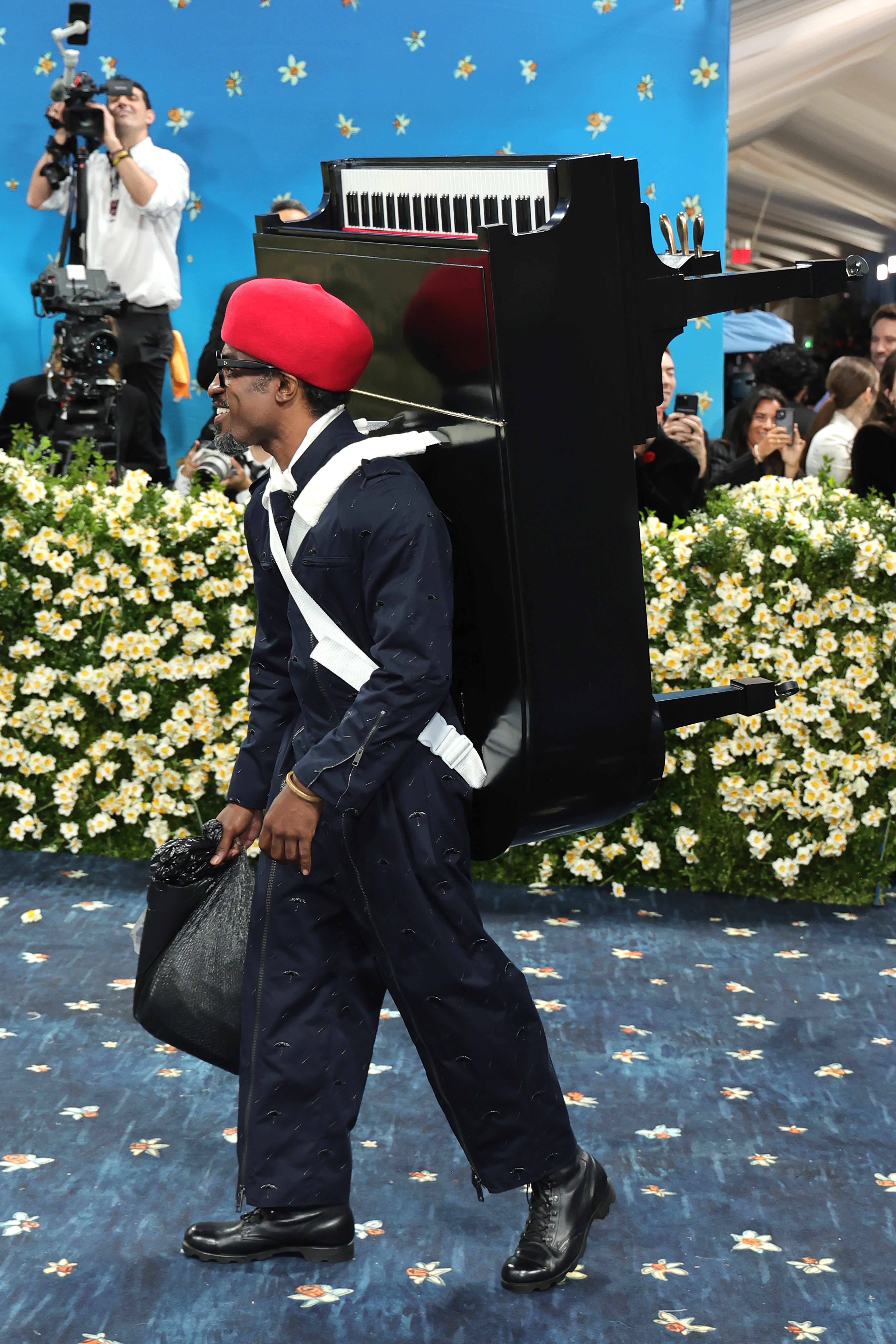 The 49-year-old singer-songwriter donned a black suit with speckled beading and zipper details on the sleeves. He embellished the ensemble with a red hat and chunky loafers