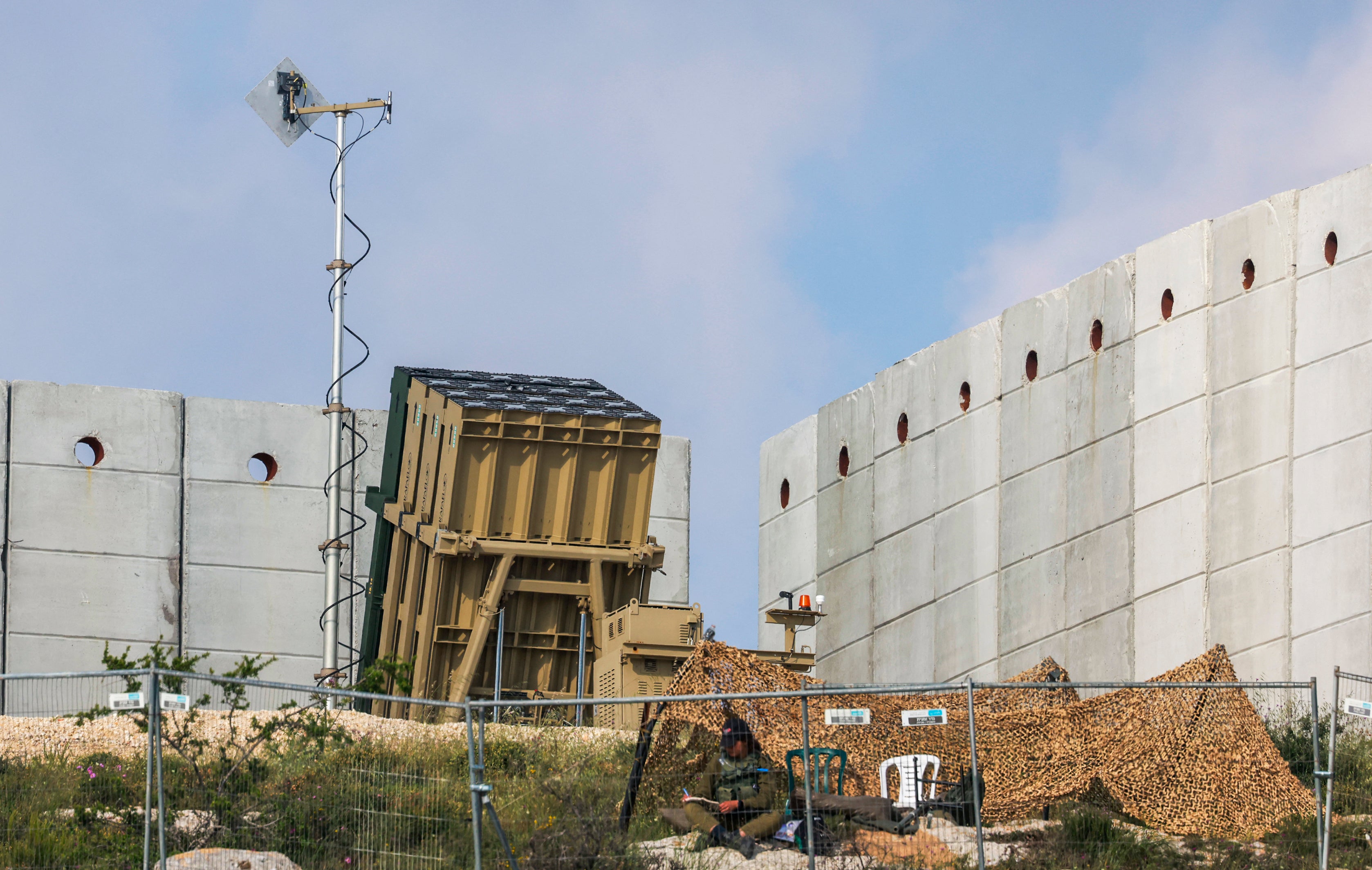 An Israeli soldier is seen taking position in front of a battery of an Iron Dome air defense system in Jerusalem. Trump's 'Golden Dome' harkens back to the idea of Israel's Iron Dome, but it has key differences
