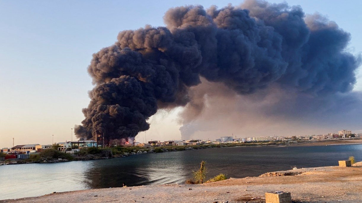 A view shows a large plume of smoke and fire rising from fuel depot in Port Sudan
