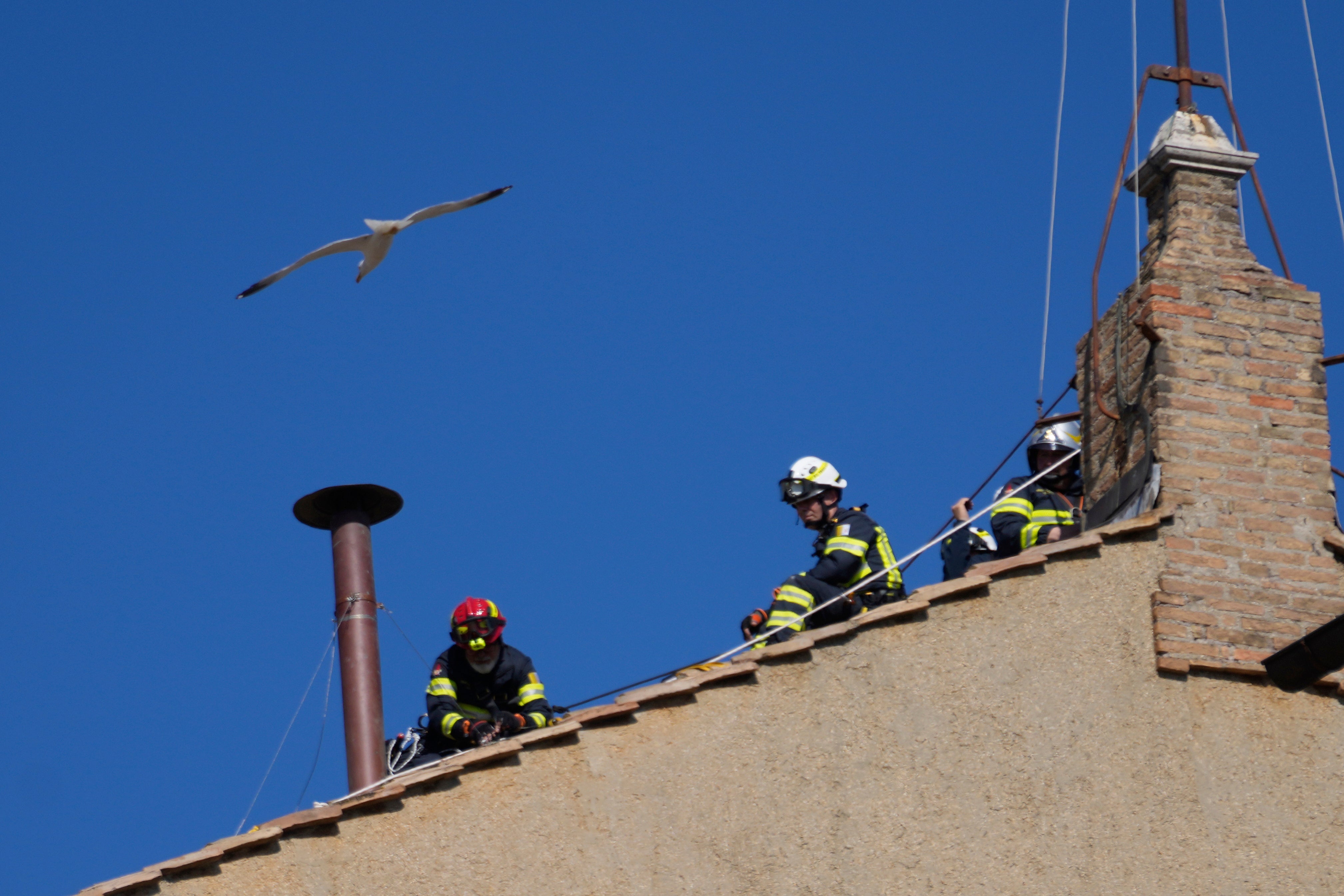 Workers installing the chimney on the Sistine Chapel, from which white smoke will emerge when a pope has been elected