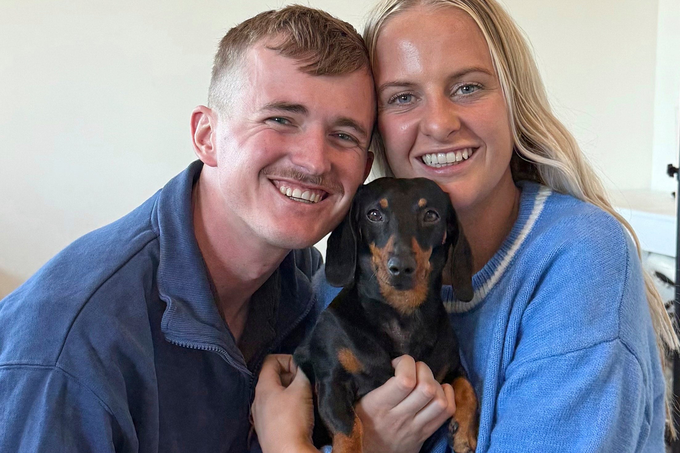 Georgia Gardner and partner Josh Fishlock hold Valerie, their miniature dachshund after being reunited on Kangaroo Island in South Australia after Valerie was missing for 540 days, Tuesday, May 6, 2025.
