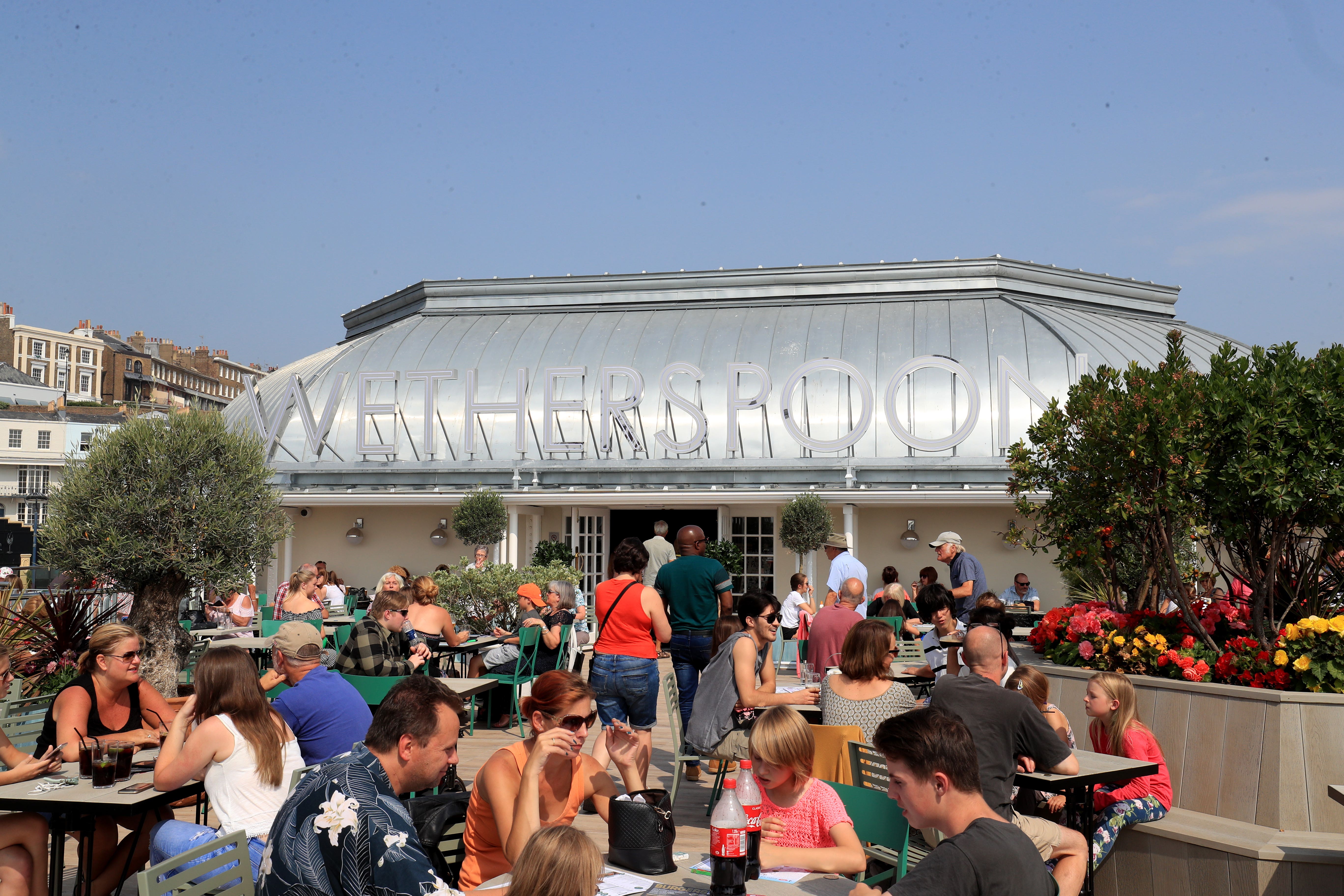 Custoemrs enjoy a drink in the sunshine at JD Wetherspoon’s Royal Victoria Pavilion