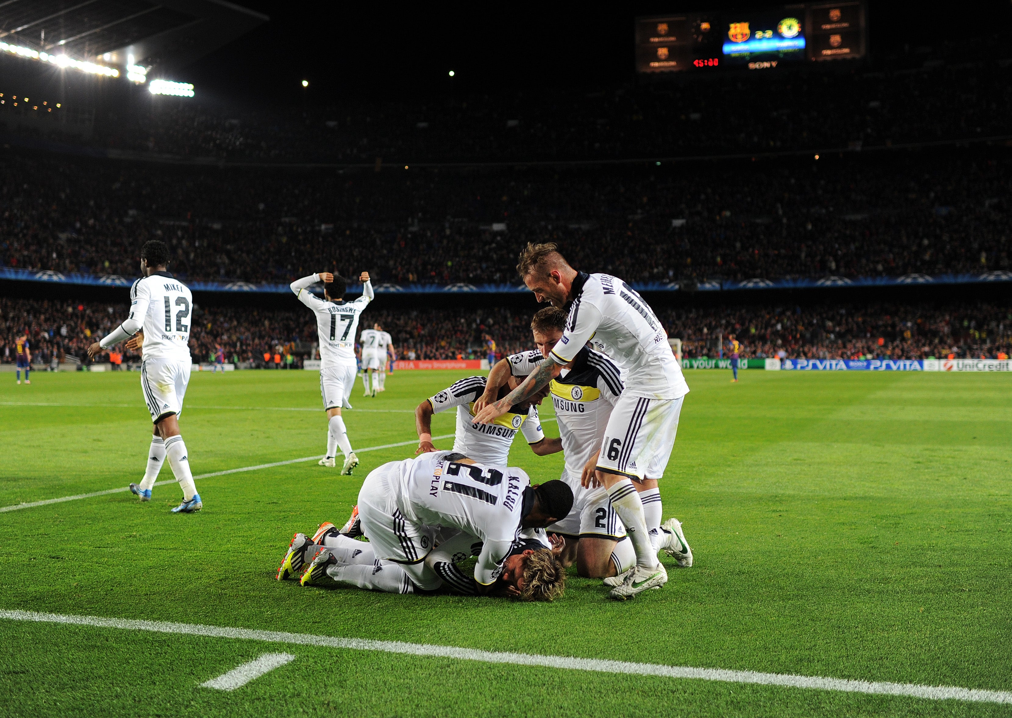 Fernando Torres of Chelsea lays on the pitch celebrating with his teammates in 2012