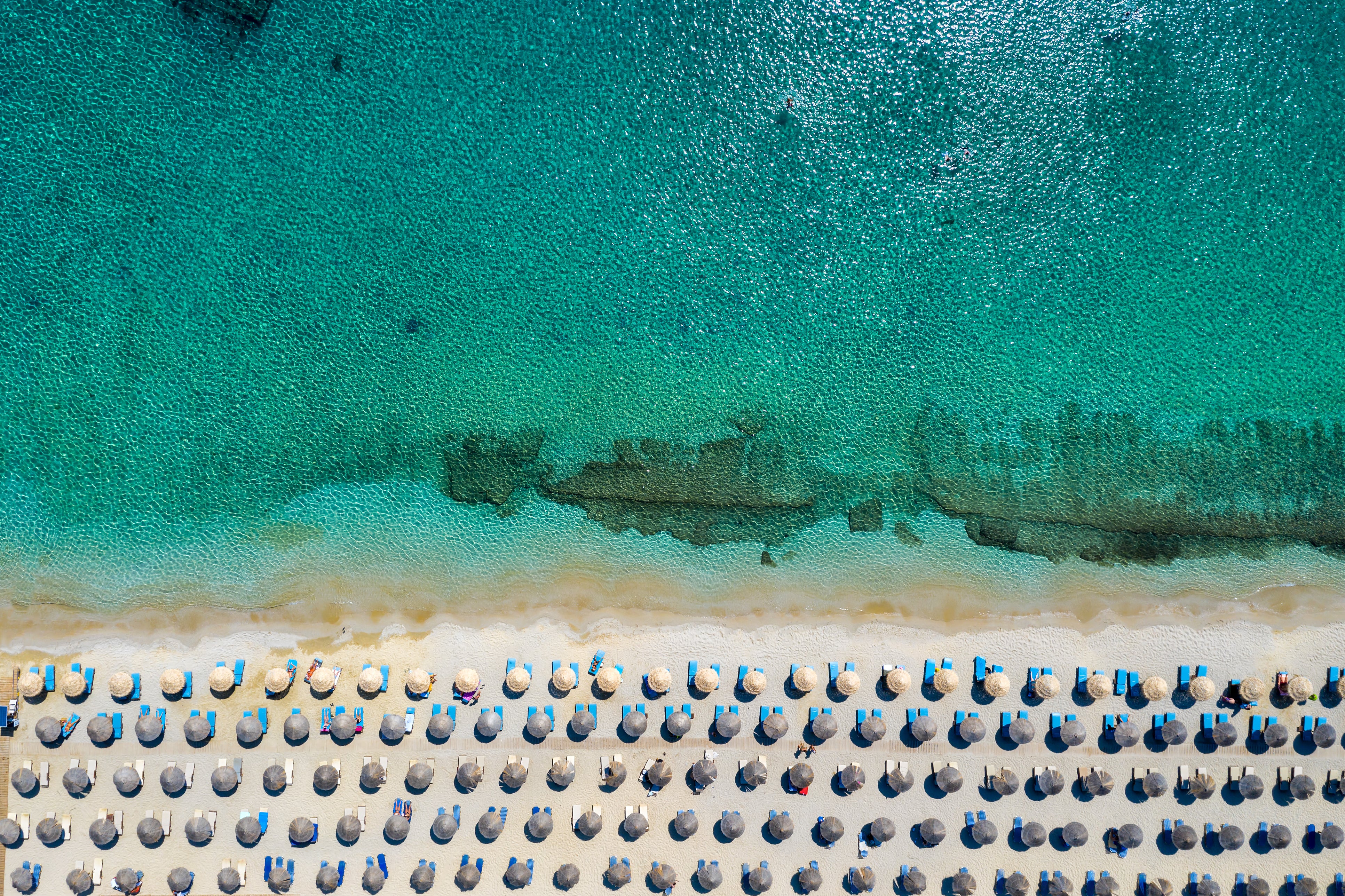 Kalafatis beach is home to aquamarine waters and golden sand