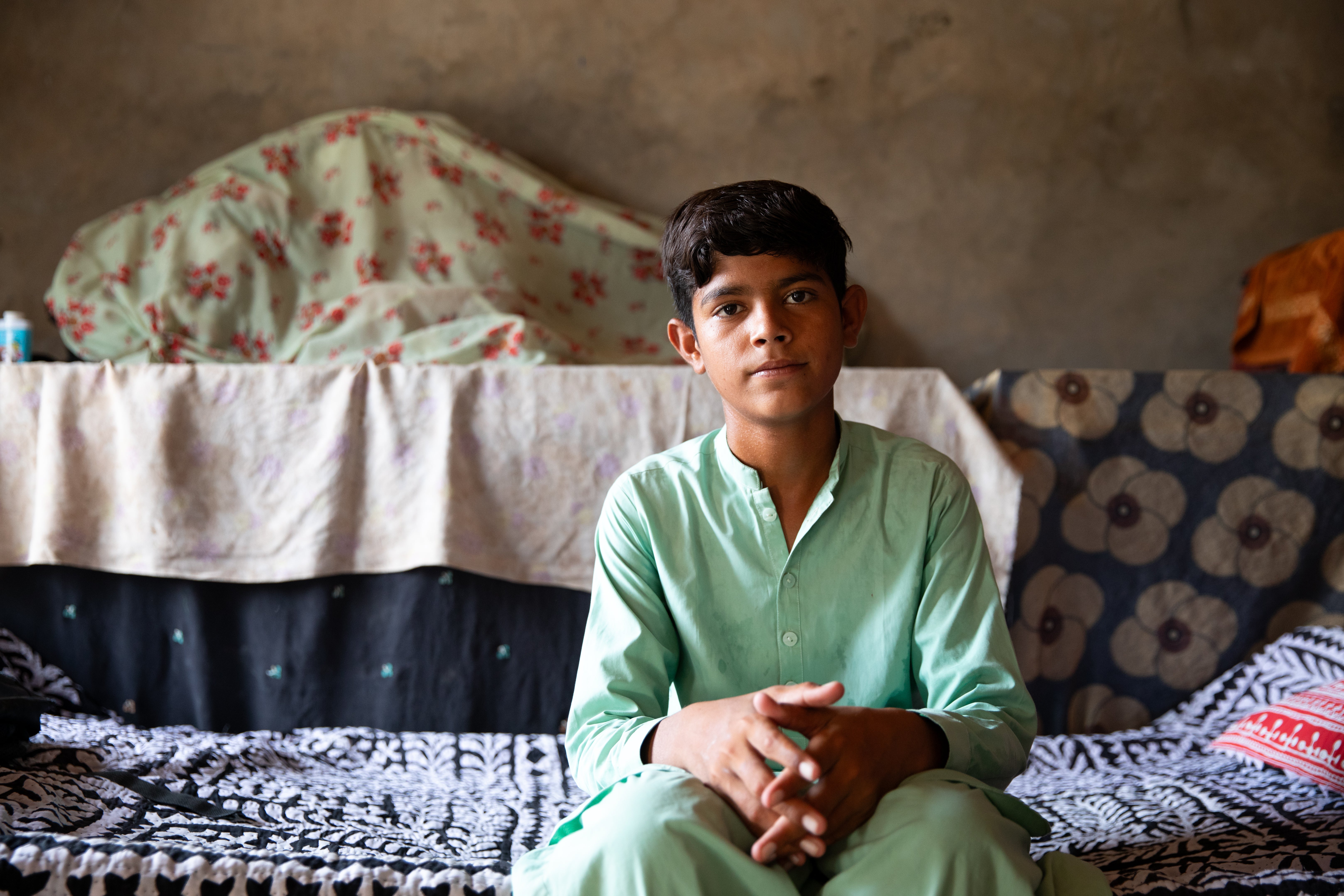 13-year-old Zain, pictured at home, who described the daily struggles faced by his community due to climate and heat-related challenges