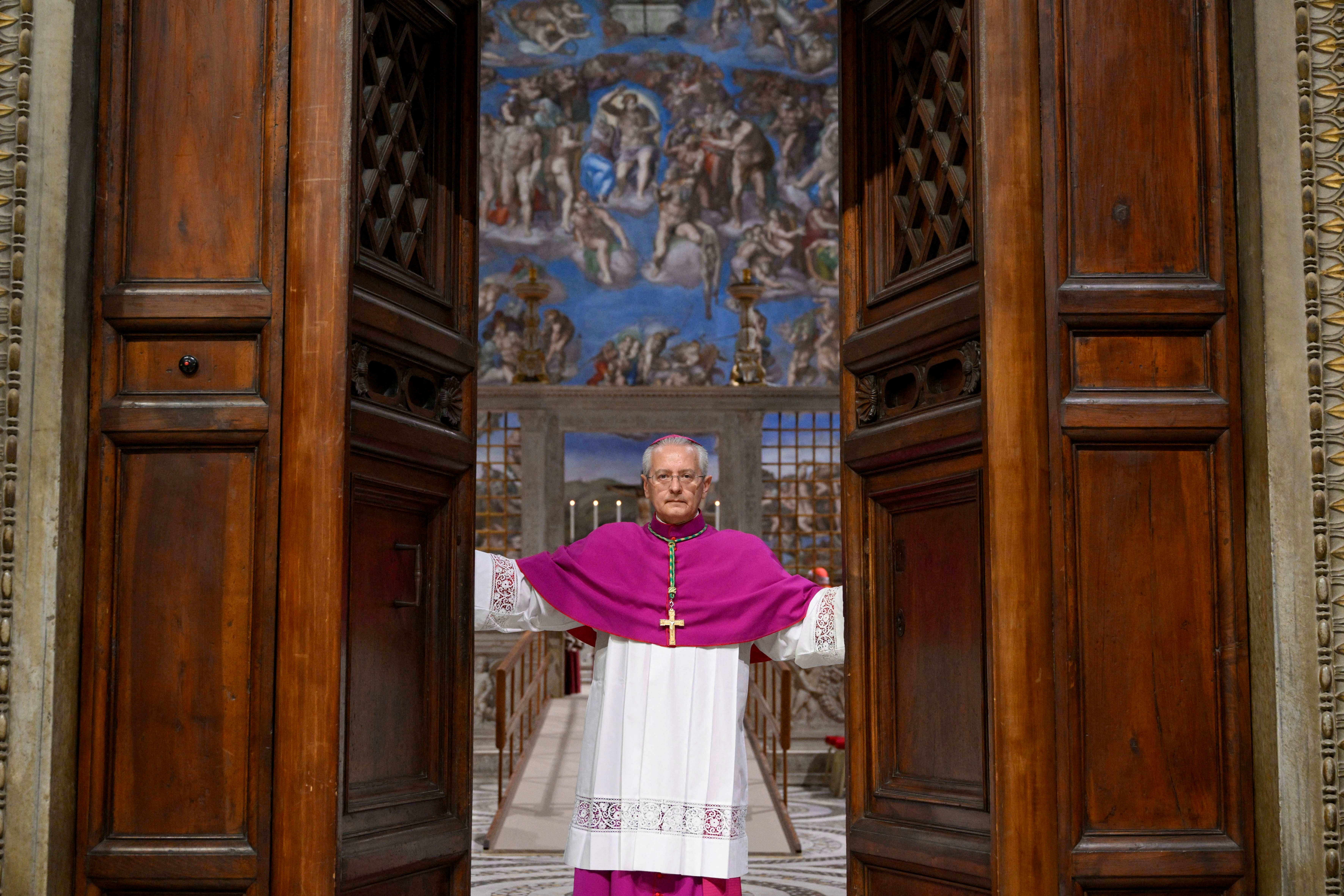 Archbishop Diego Giovanni Ravelli closes the doors of the Sistine Chapel for the conclave to begin