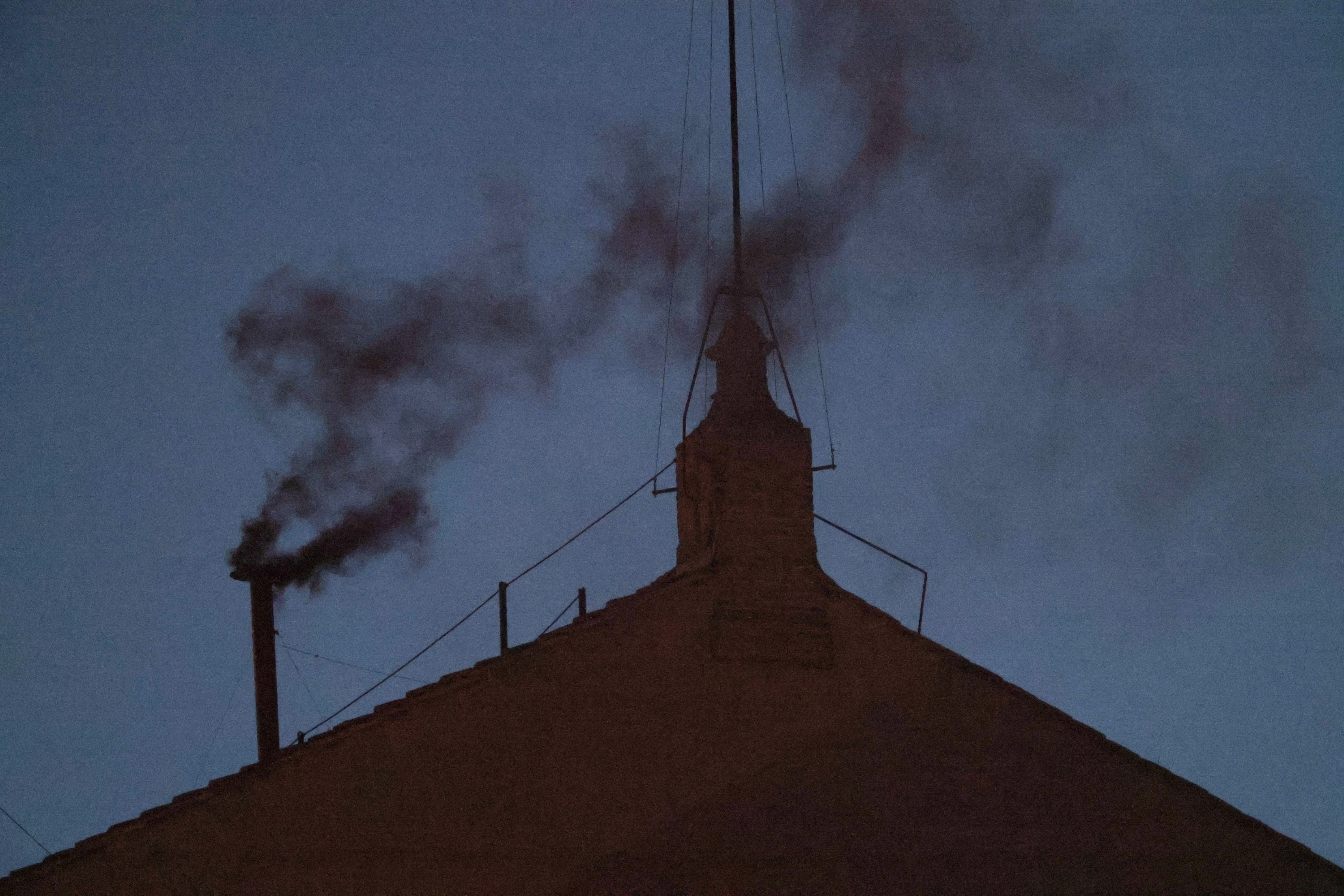 Black smoke has funnelled out of the Sistine Chapel