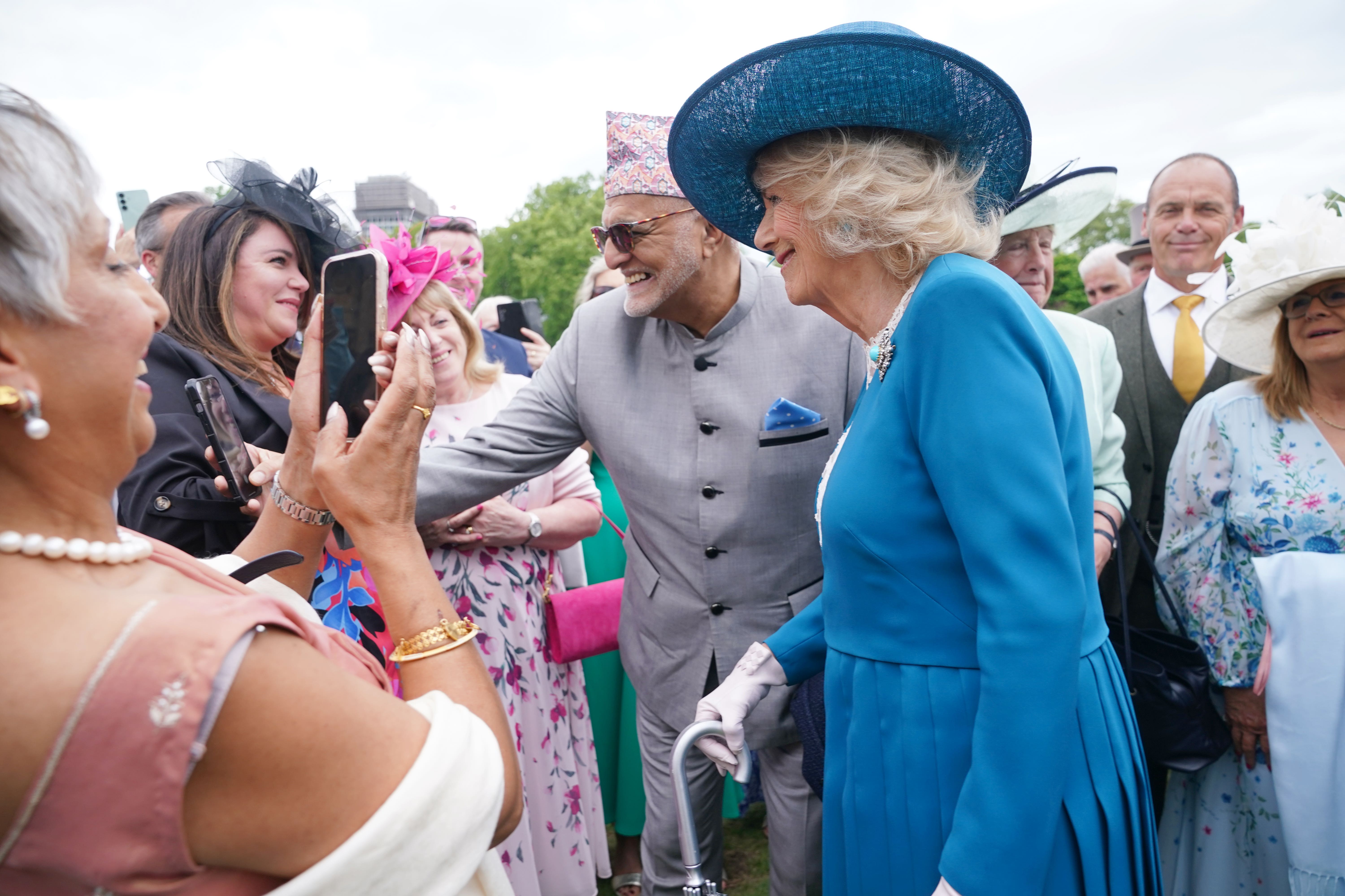 Camilla speaks to guests during a garden party at Buckingham Palace (Yui Mok/PA)