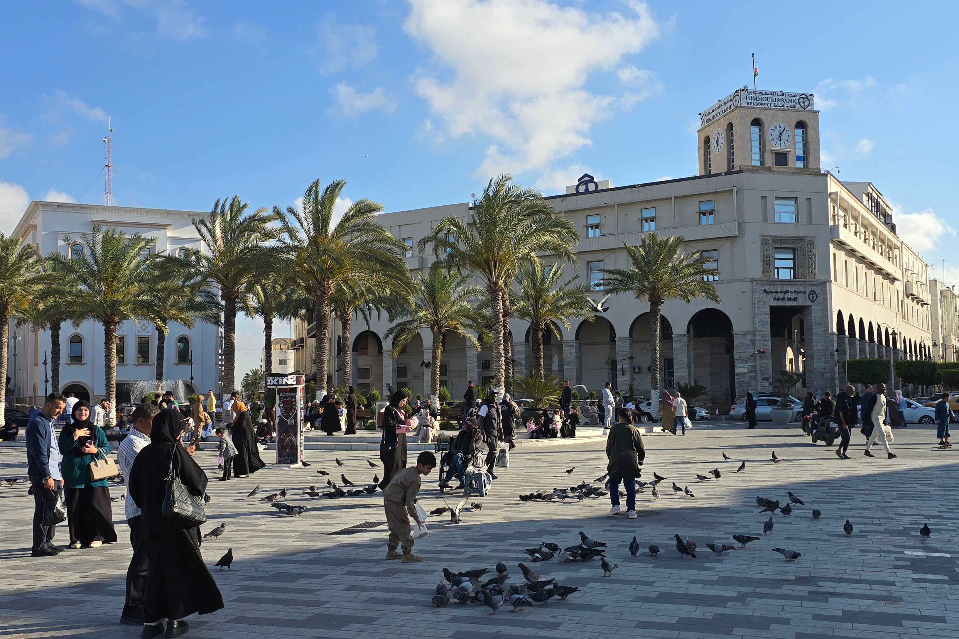 Libyans walk around in Tripoli's Martyrs Square on April 28, 2025. The Trump administration plans to send migrants to the divided country