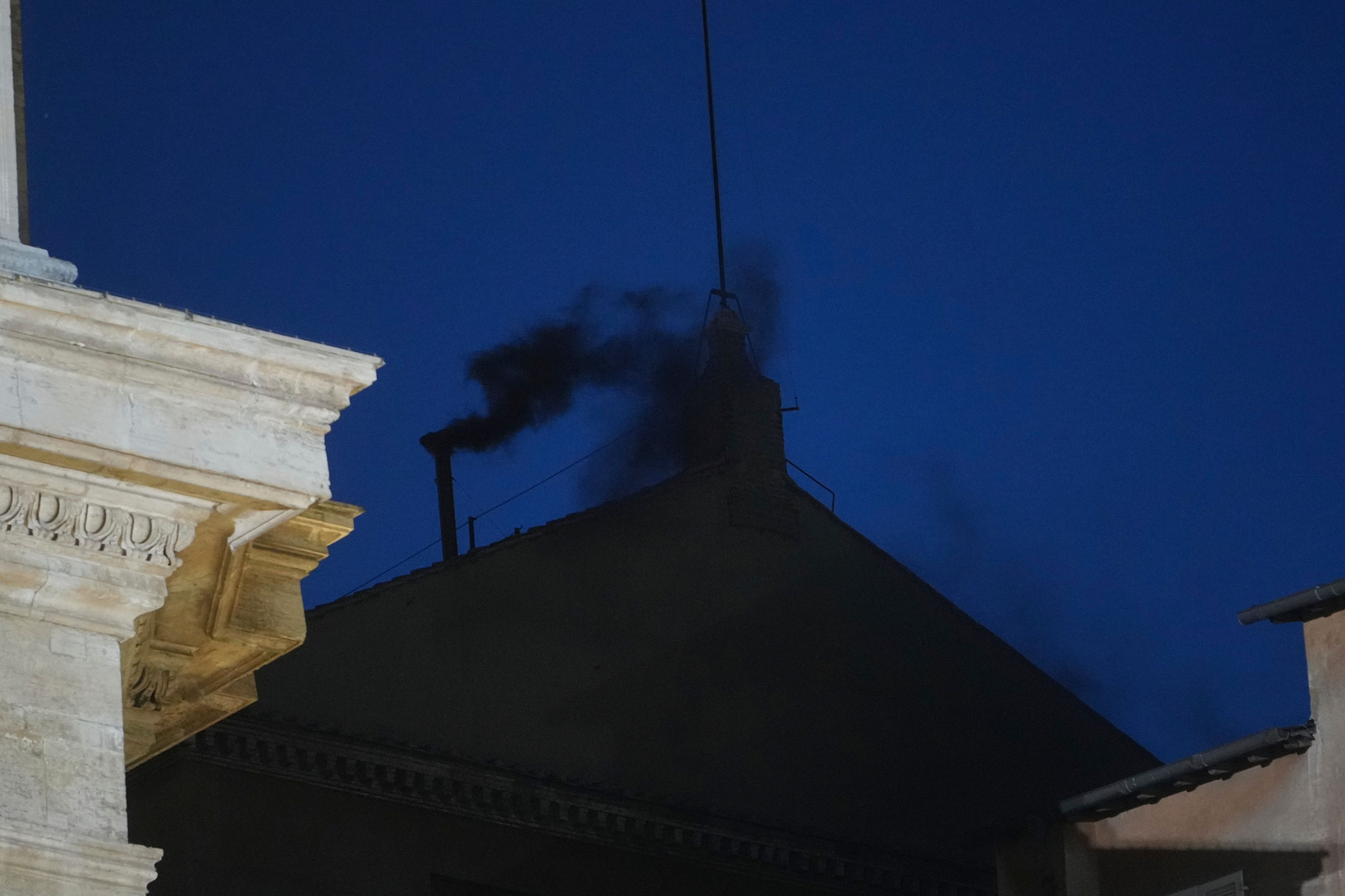 Black smoke billows from the chimney of the Sistine Chapel (Alessandra Tarantino/AP)