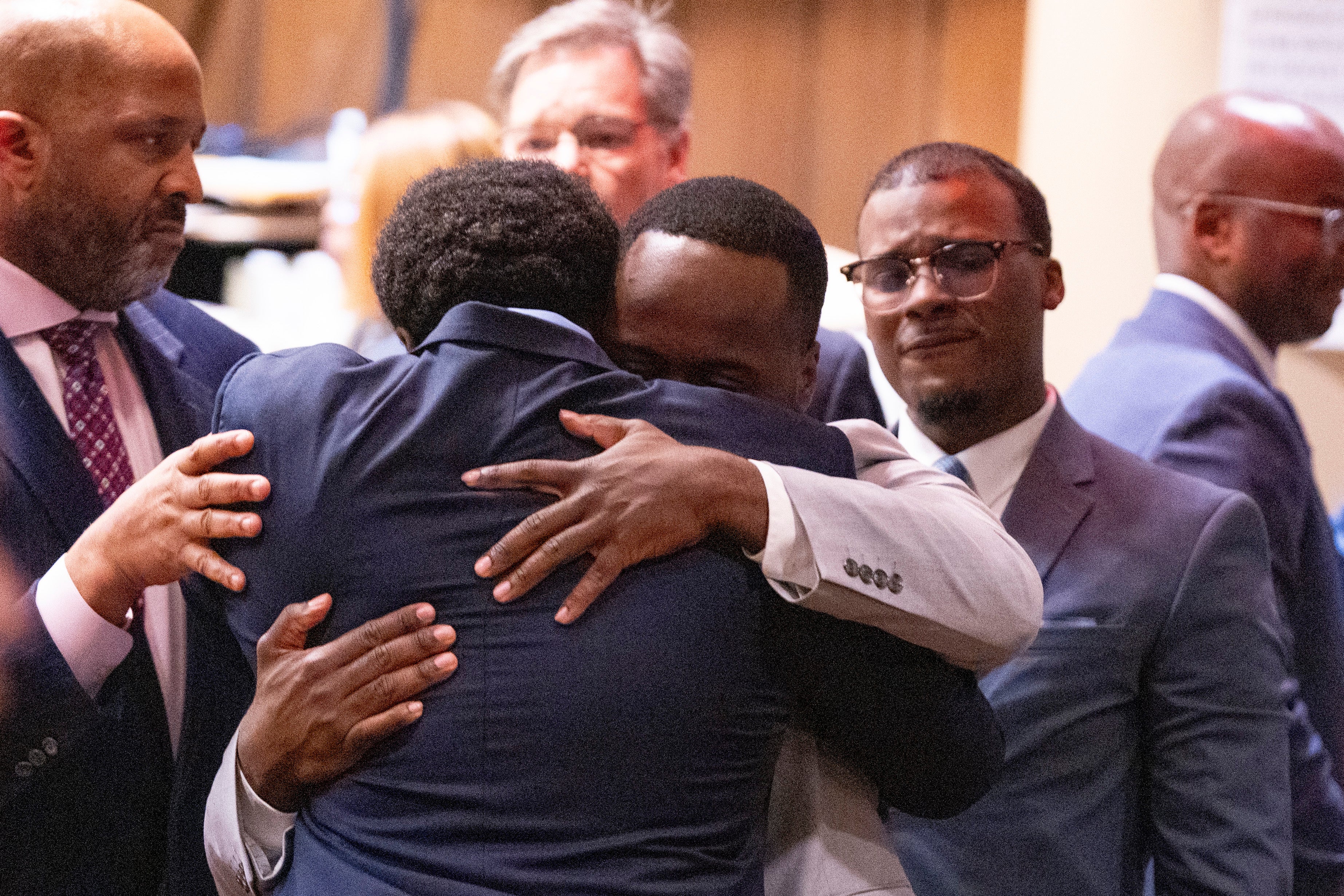 Former Memphis police officers Demetrius Haley, left, and Tadarrius Bean, center, hug as Justin Smith Jr., right, becomes emotional behind them after they were acquitted of state charges, including second-degree murder, in the fatal beating of Tyre Nichols