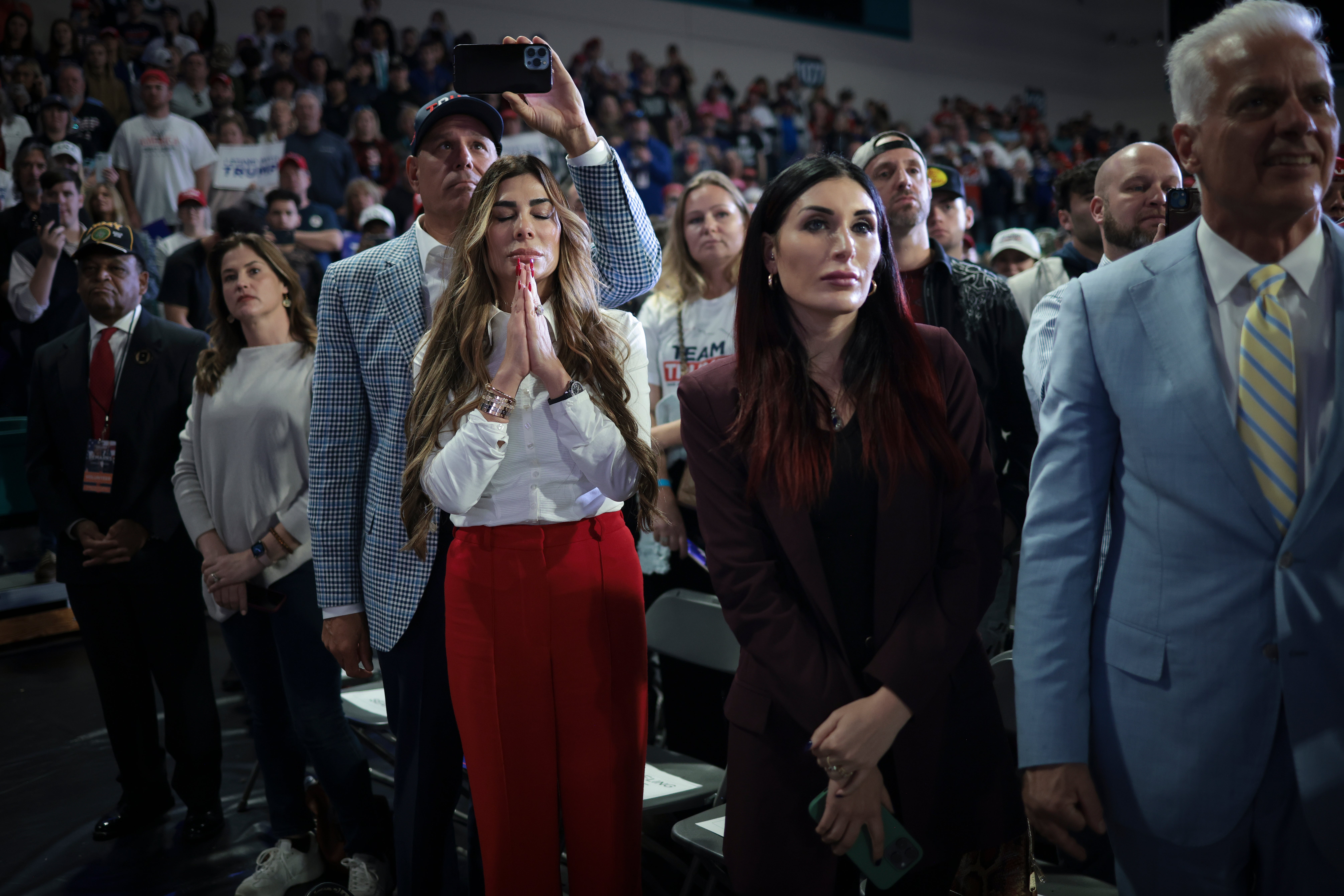 Trump supporters Siggy Flicker, left, and far-right activist Laura Loomer, listen as Republican presidential candidate and former President Donald Trump speaks during a Get Out The Vote rally at Coastal Carolina University on February 10, 2024 in Conway, South Carolina