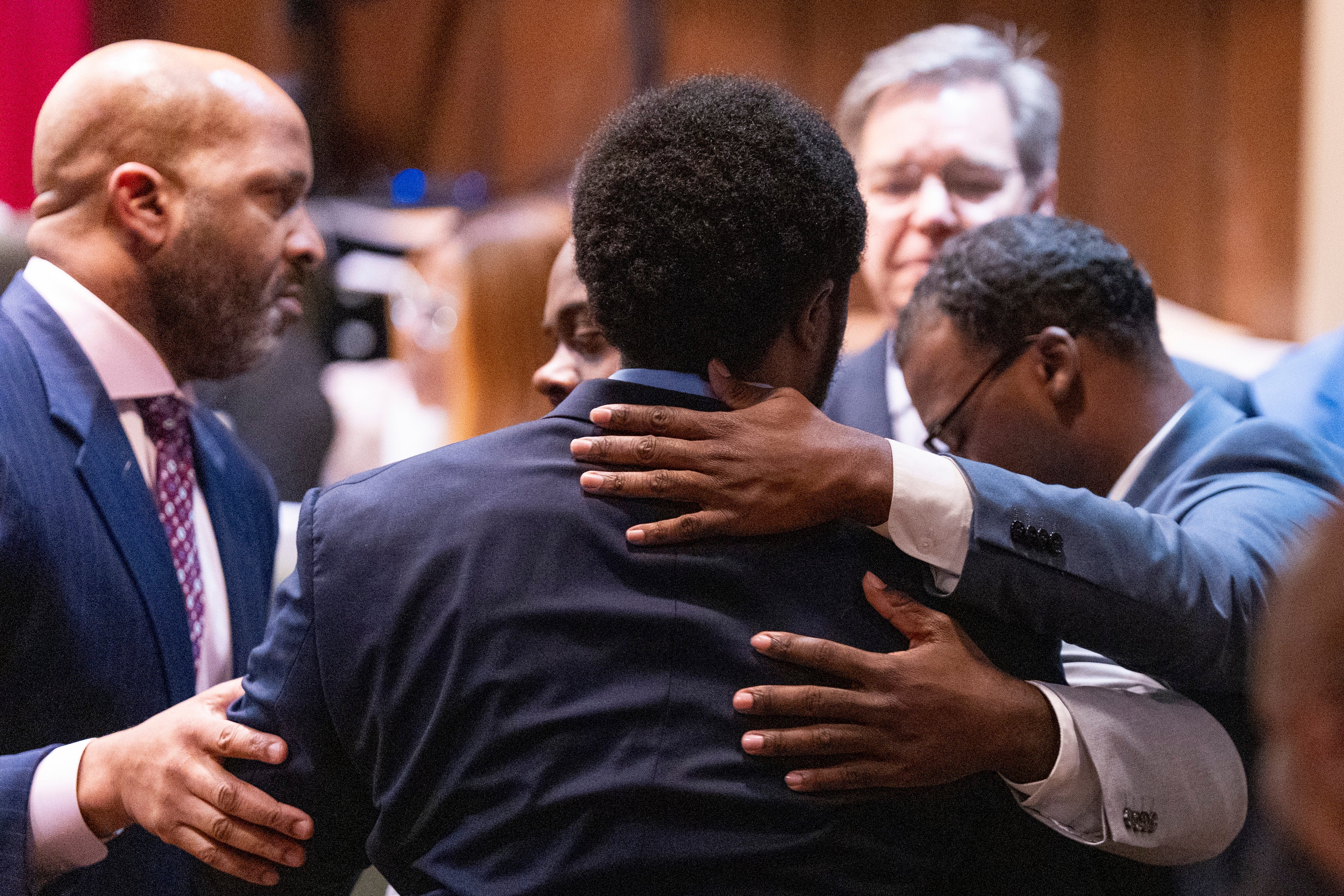 Demetrius Haley (center), Tadarrius Bean (left) and Justin Smith Jr (right) hug after they were acquitted of state charges Wednesday