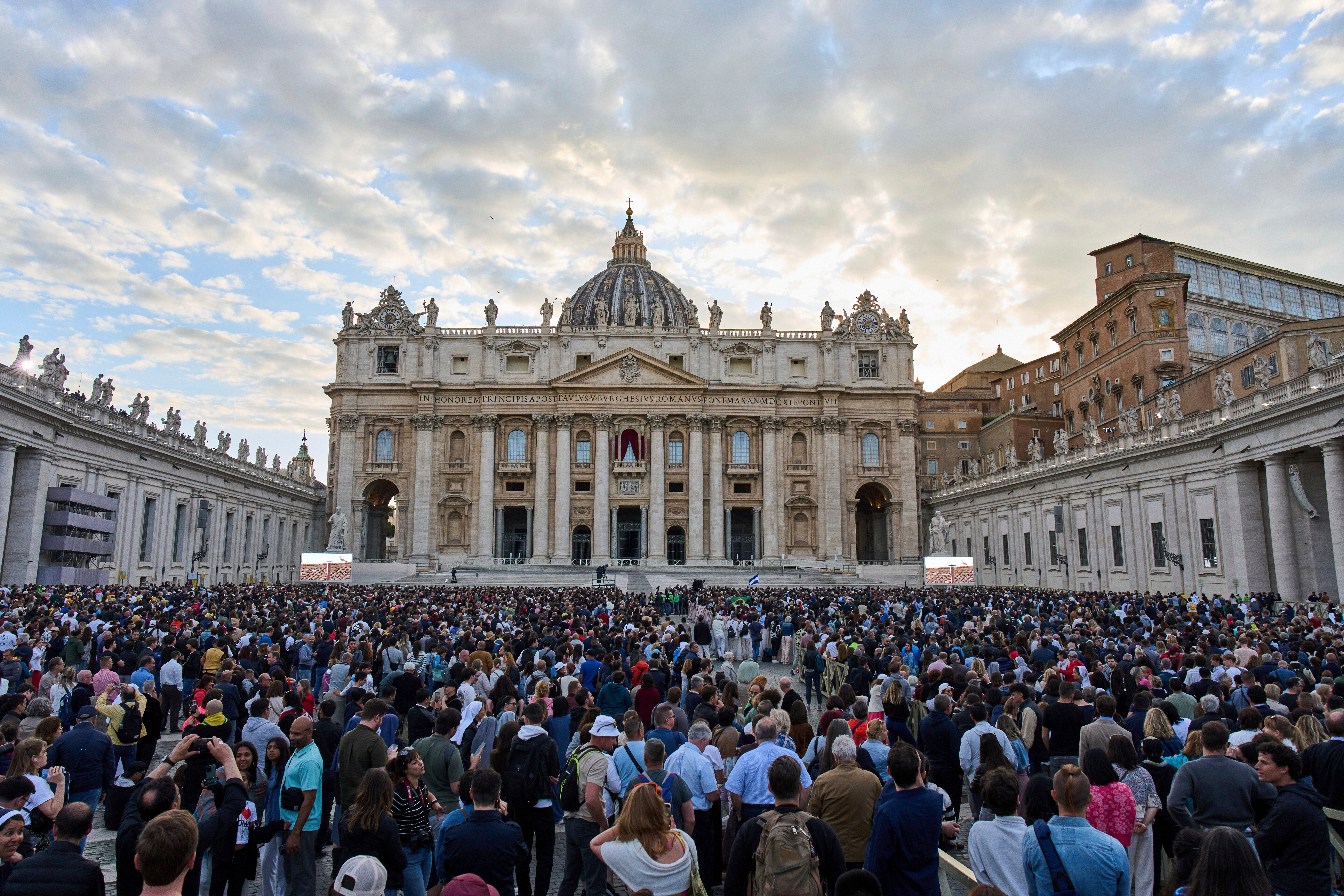 People gather in St. Peter’s Square to await a glimpse of smoke signalling whether a new Pope has been elected