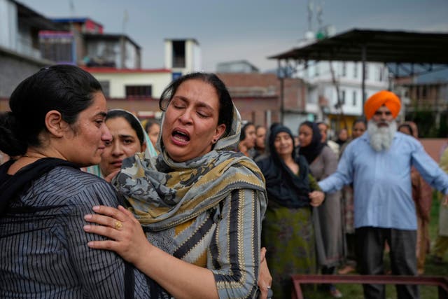 <p>The widow of Amarjeet Singh, 51, killed in Pakistani artillery shelling, is comforted during his cremation in Poonch along the Line of Control, in Indian-controlled Kashmir</p>