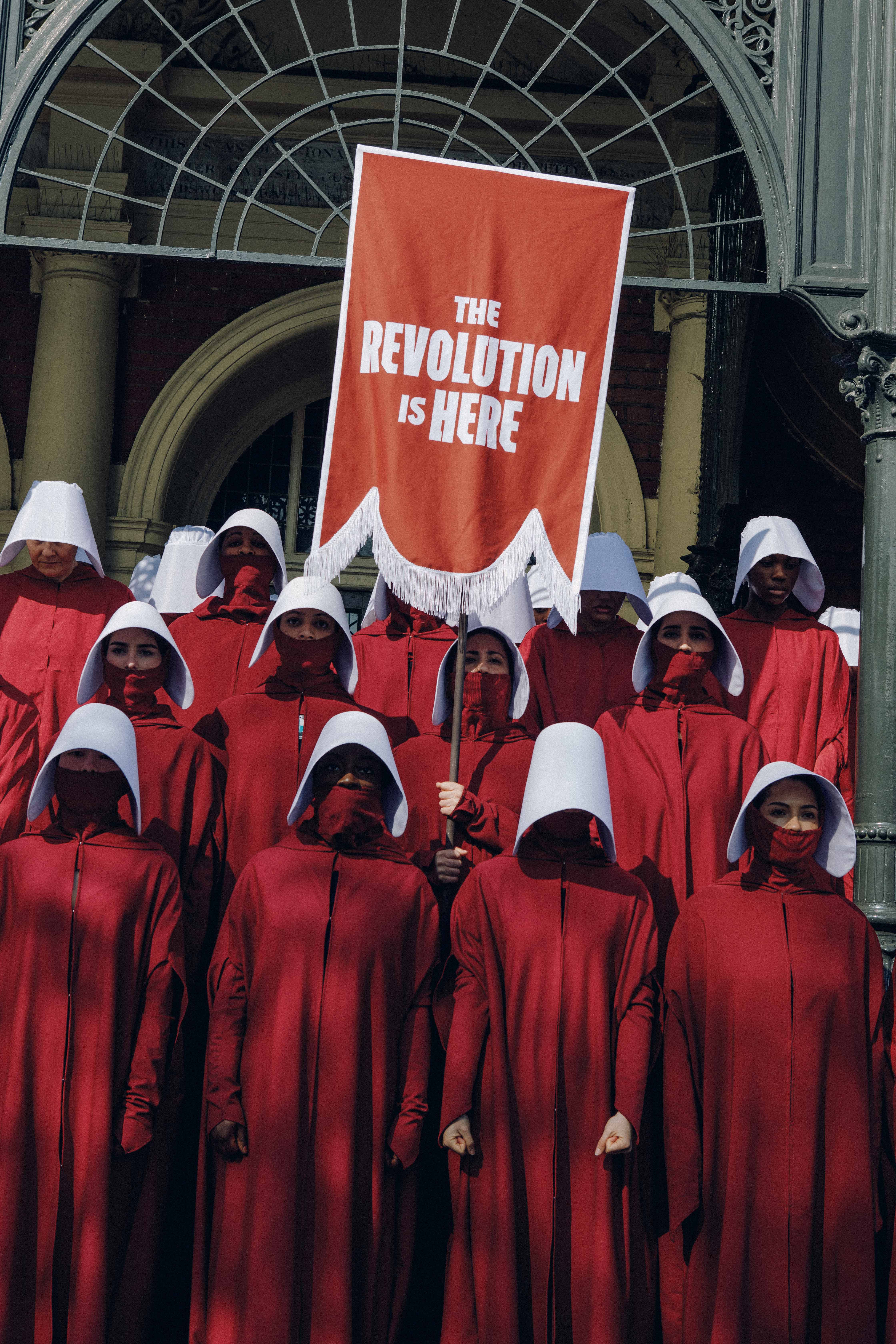 Thirty handmaids on the steps of Battersea Town Hall to mark the release of the show's sixth season