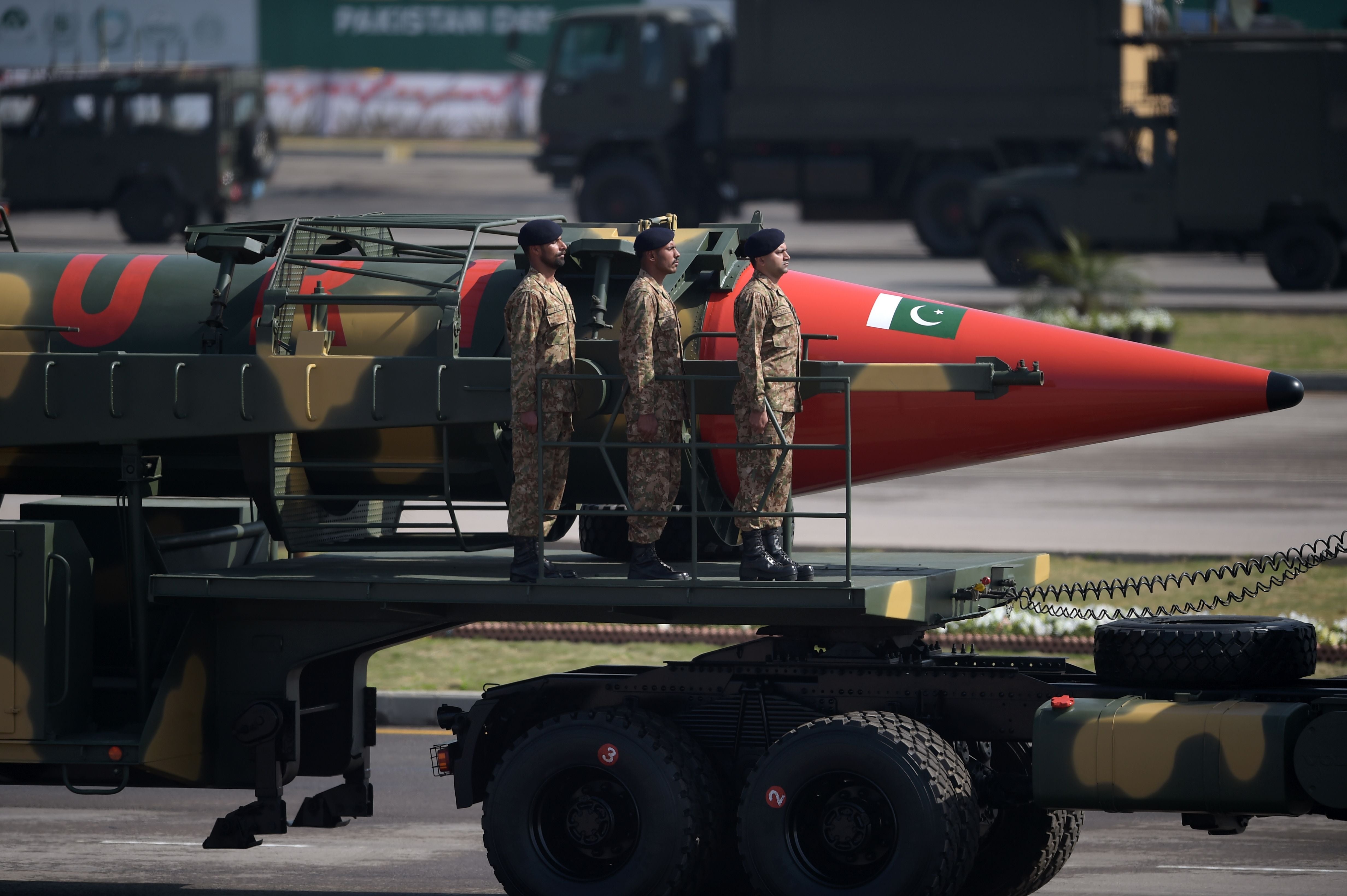 Pakistani military personnel stand beside a Ghauri nuclear-capable missile during a Pakistan Day military parade in Islamabad