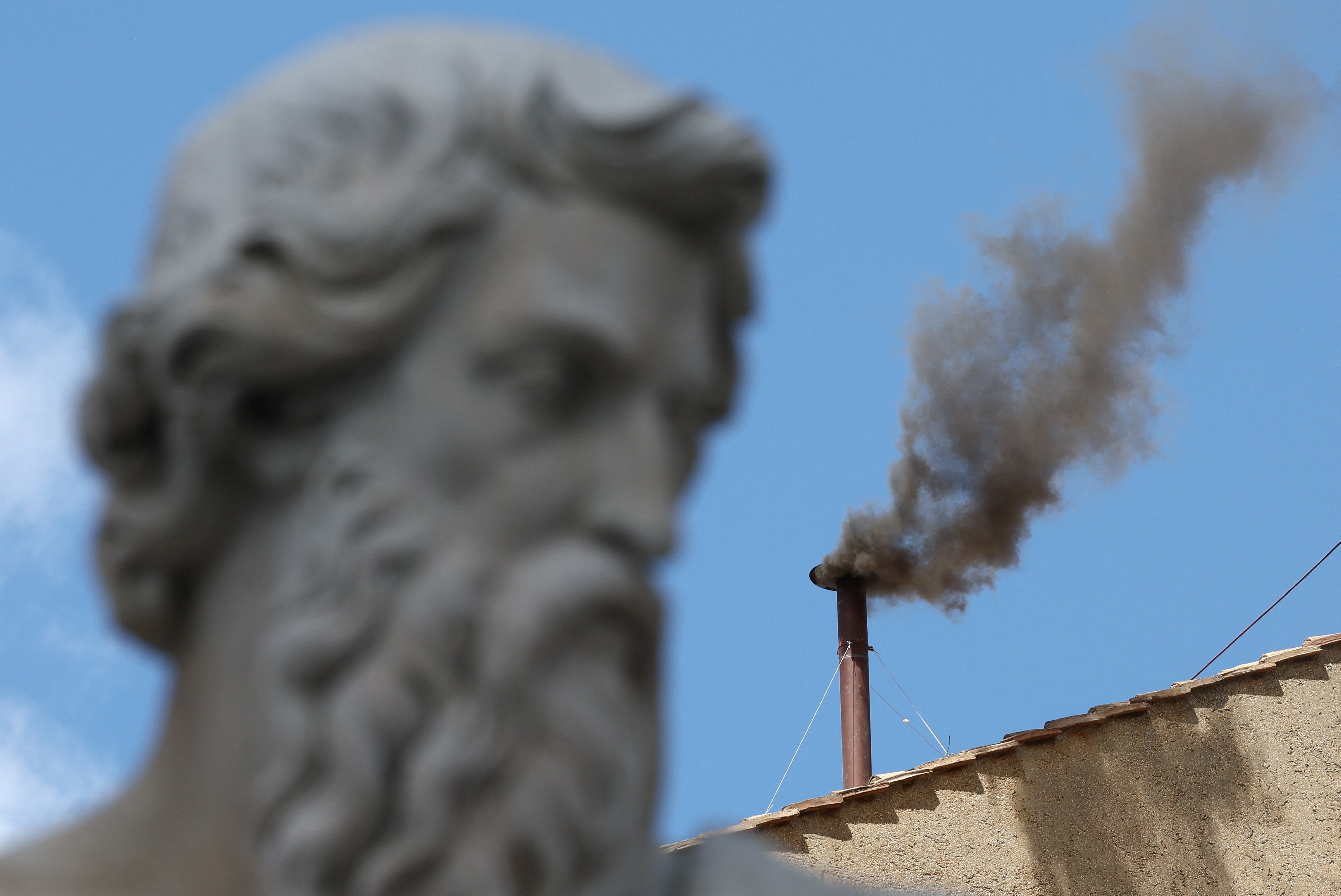 Black smoke rises from the chimney of the Sistine Chapel as the cardinals fail to select a new Pope on the morning of day two of the conclave