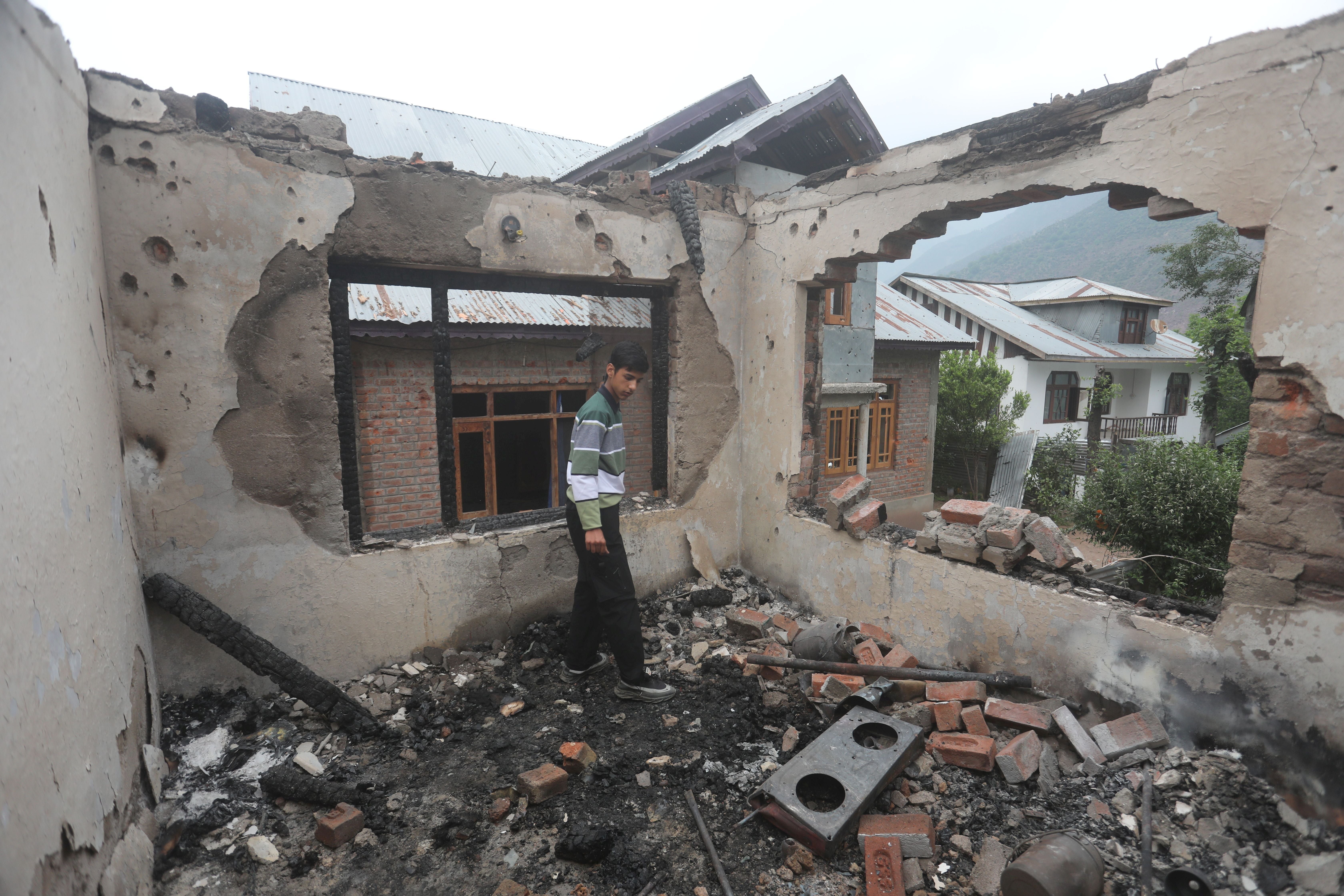 A Kashmiri boy inspects a house damaged after cross-border shelling from Pakistan, at Salamabad village in Uri, north of Srinagar