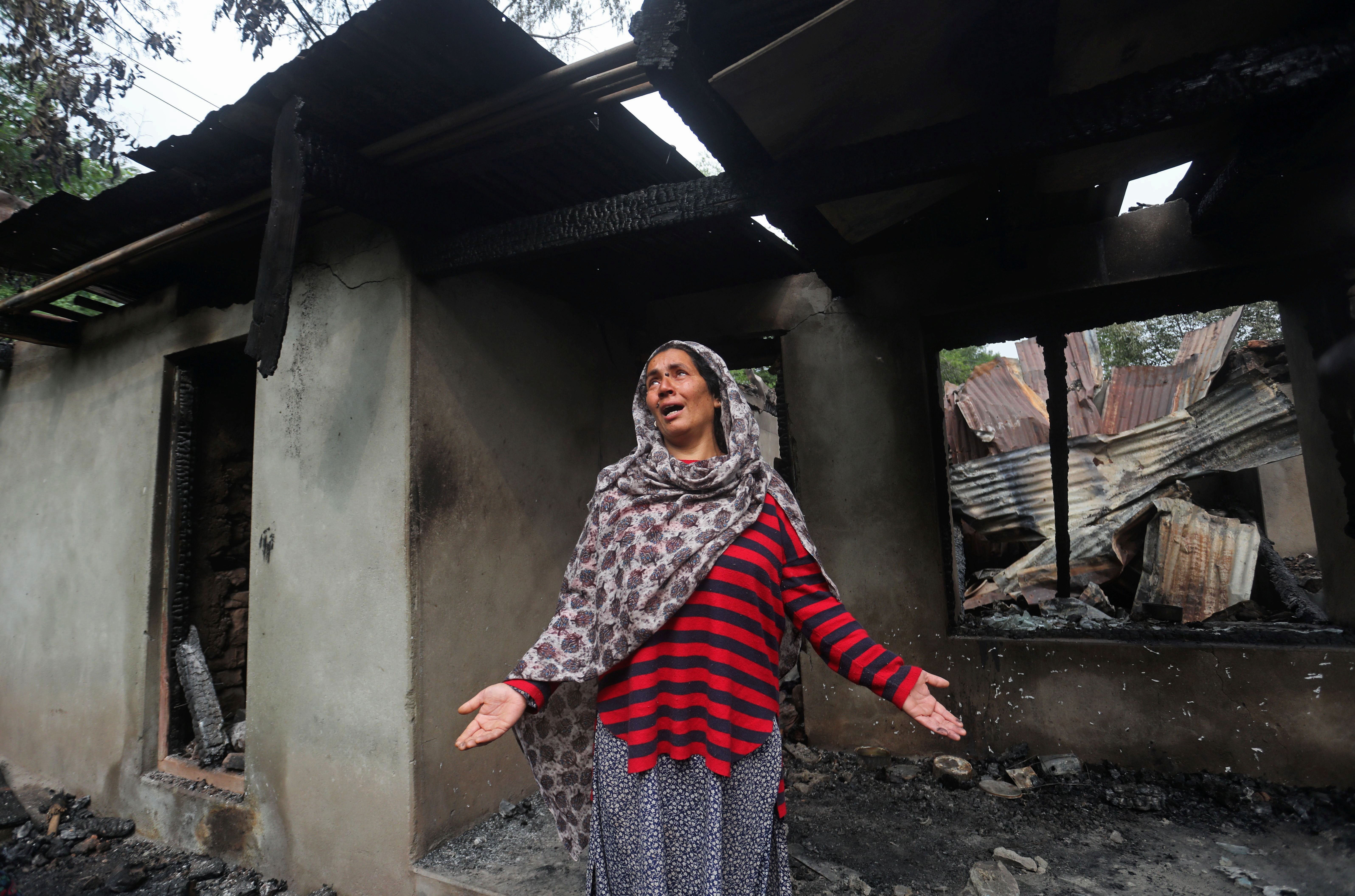 A Kashmiri woman wails inside her house damaged after cross-border shelling from Pakistan, at Salamabad village in Uri