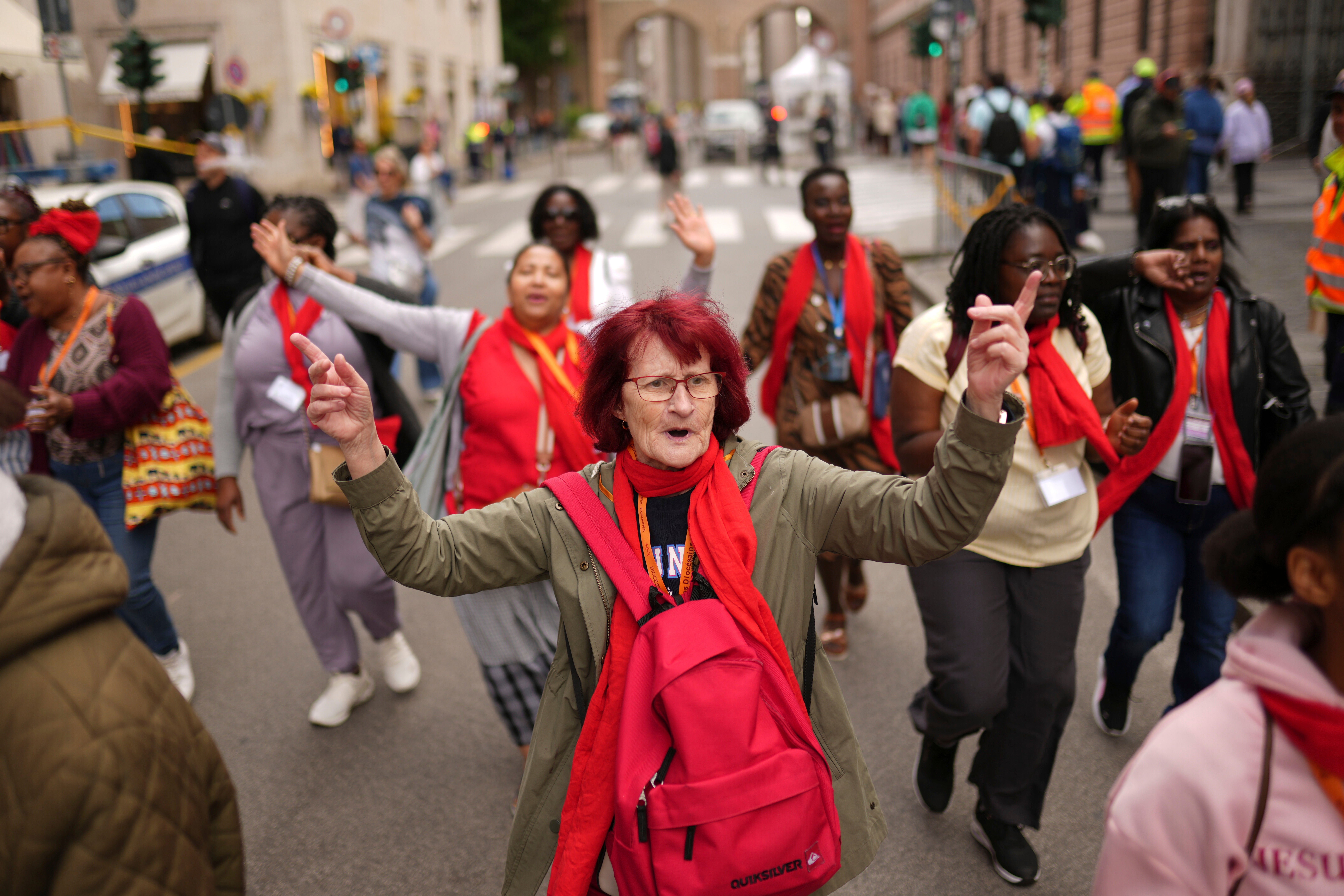 A group of faithful from France chant outside the Vatican as the second day of the conclave gets underway