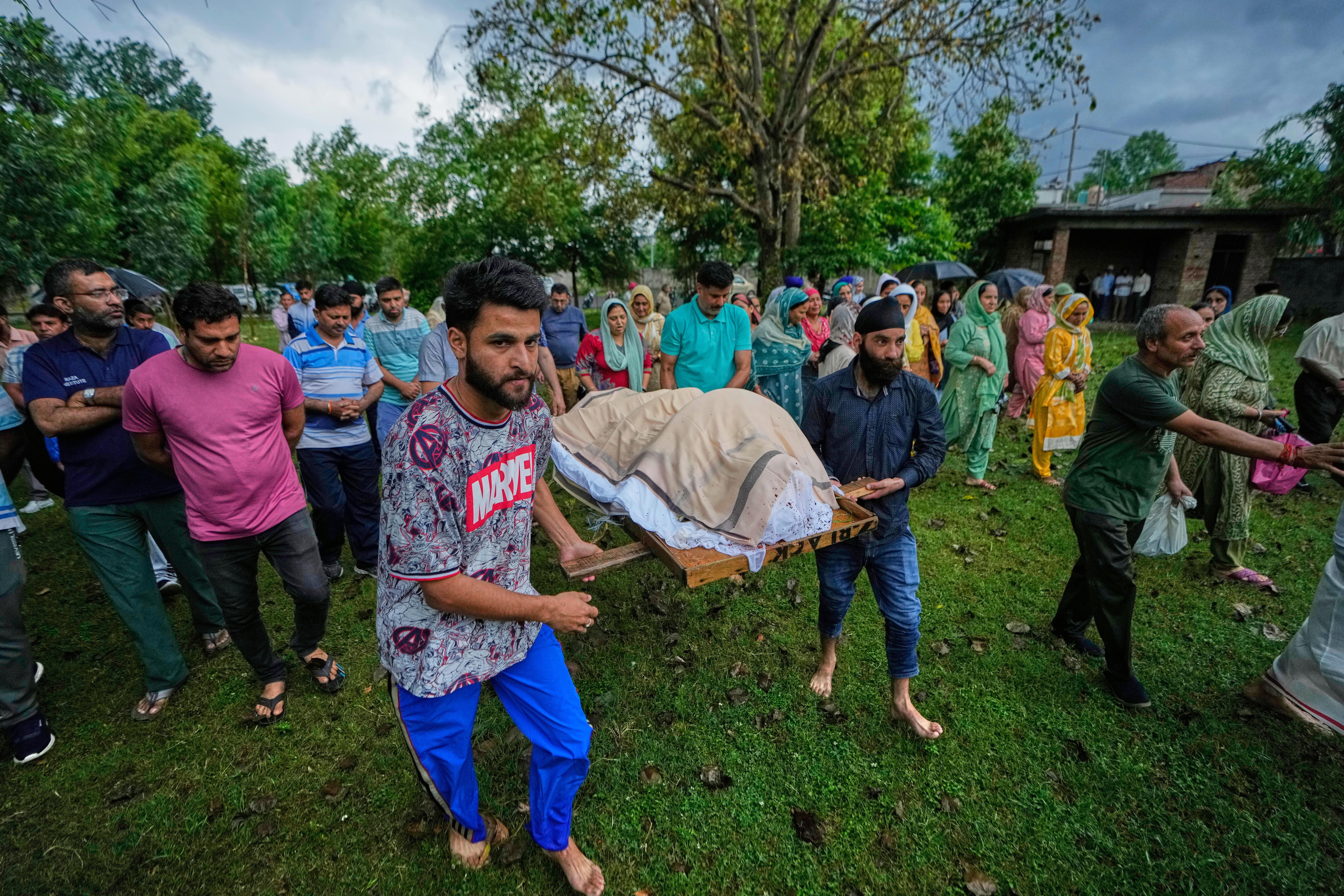Relatives and friends carry the body of Vihaan Barghava, 13, for cremation in Poonch
