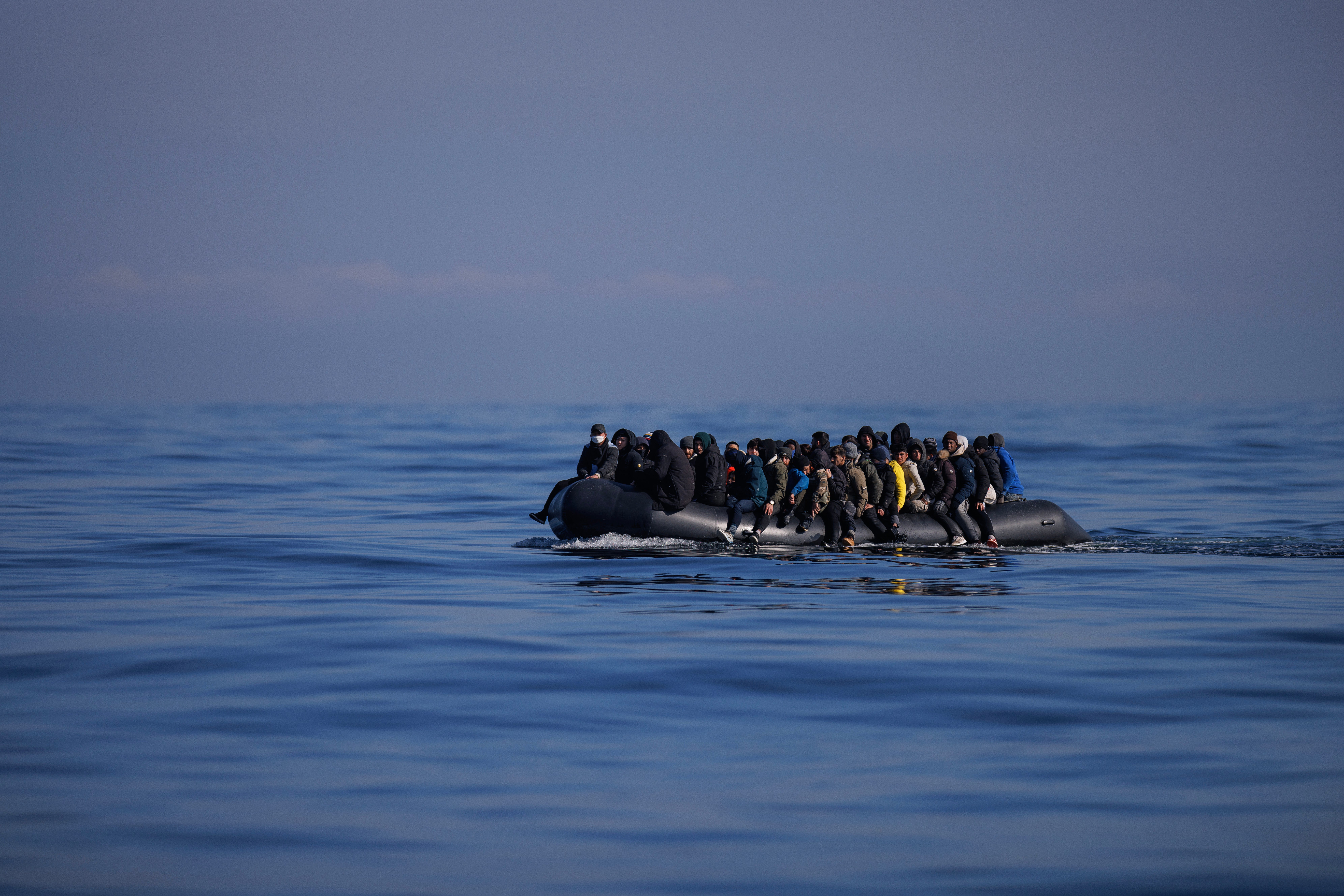 A dinghy carrying migrants crosses the Channel