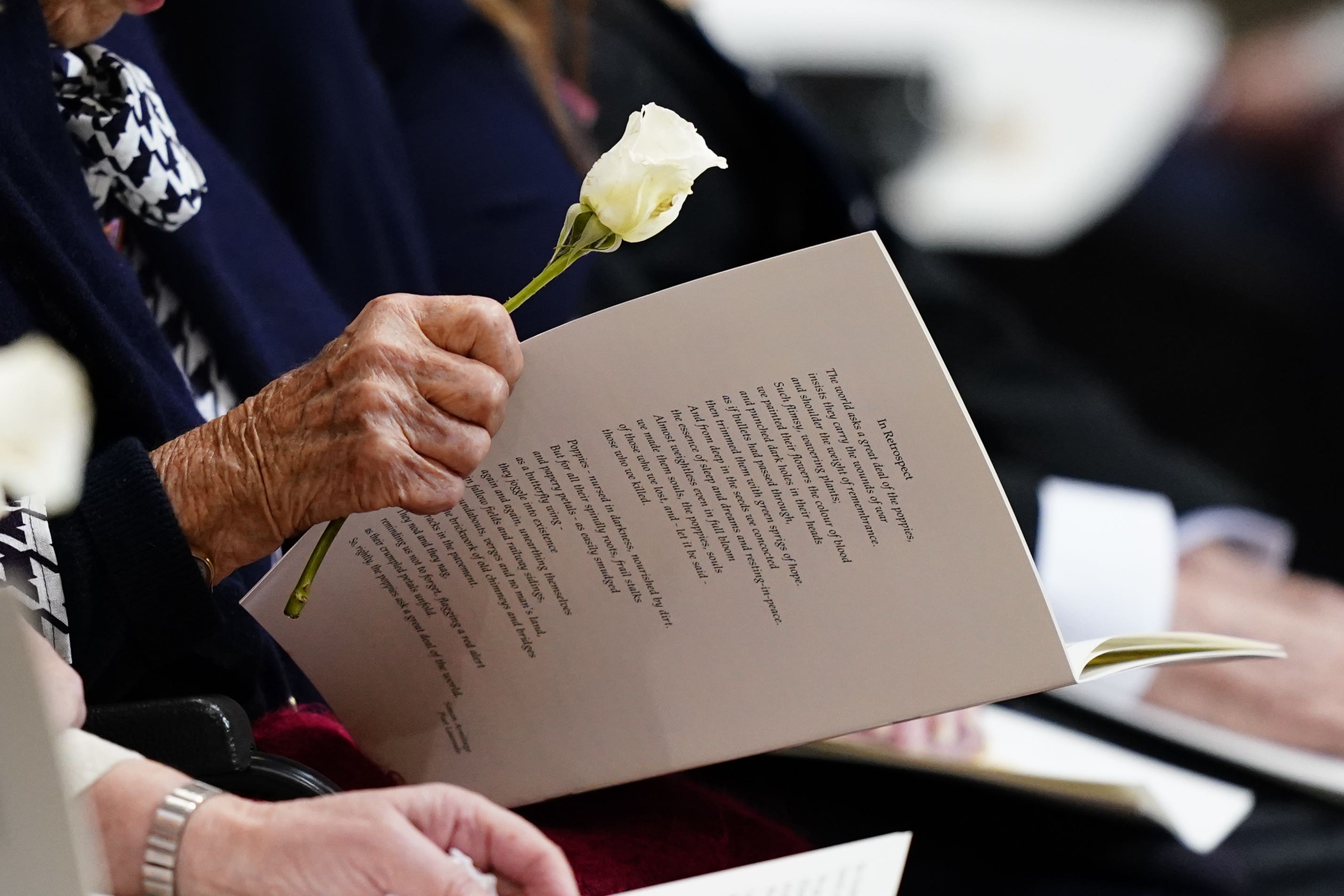 A veteran holds a white rose during a service of thanksgiving at Westminster Abbey on the 80th anniversary of VE Day (Jordan Pettitt/PA)