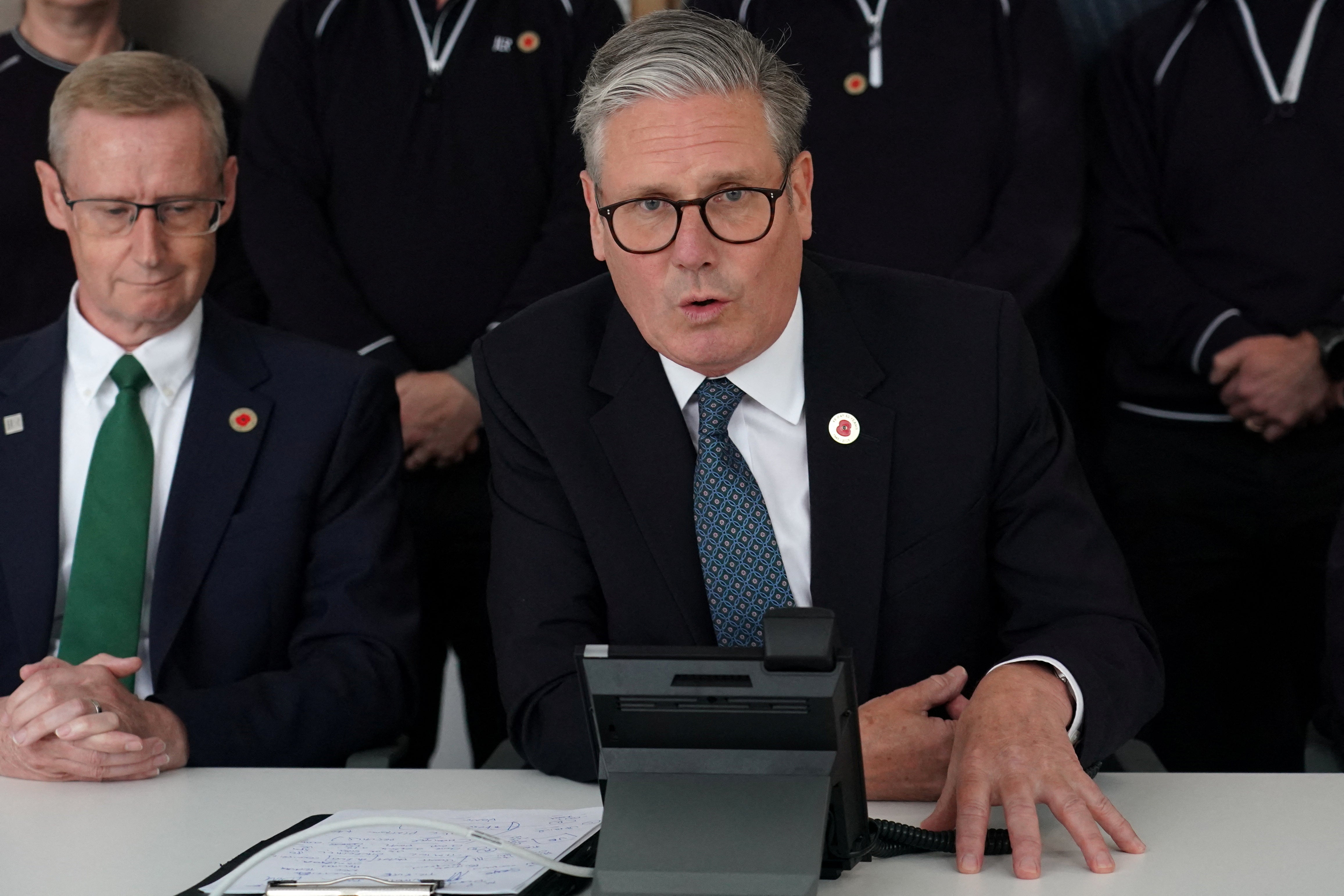 Britain’s Prime Minister Keir Starmer speaks on the phone to U.S. President Donal Trump at a car factory in the West Midlands, Britain, Thursday, May 8, 2025