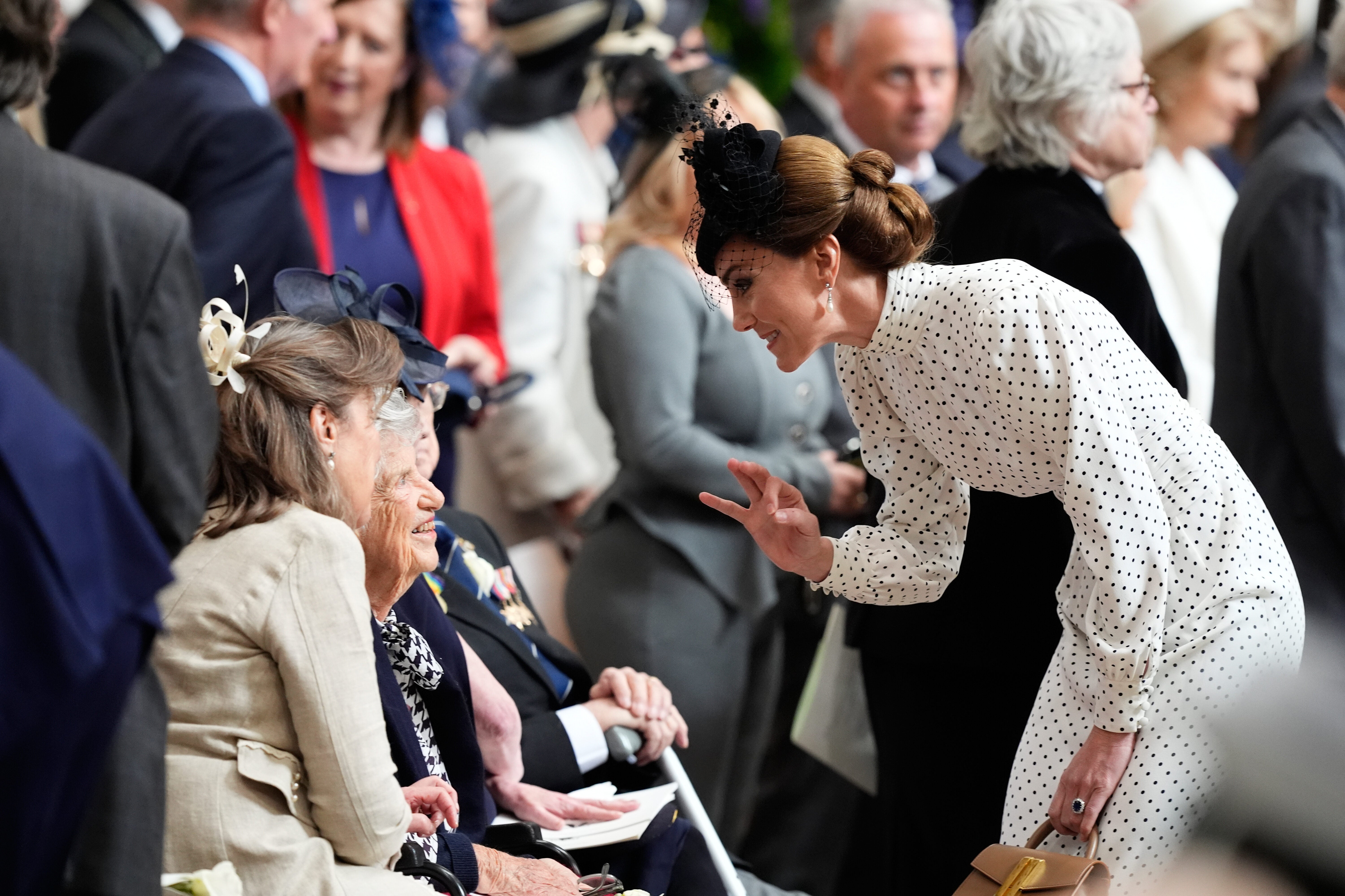 Kate, Princess of Wales, speaks to a veteran during the service of thanksgiving at Westminster Abbey