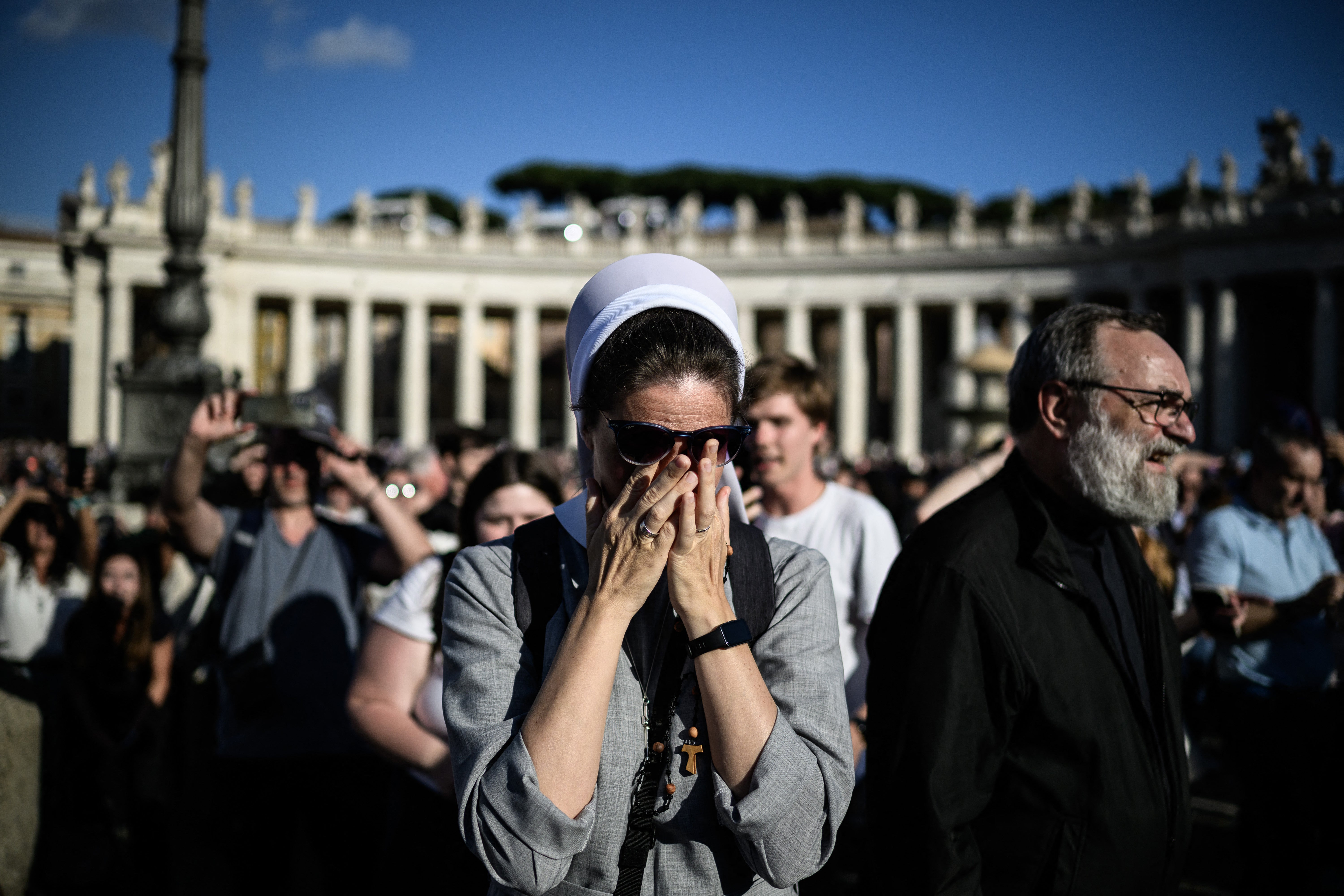 A nun reacts as white smoke signals that cardinals elected a new pope during their conclave in the Vatican