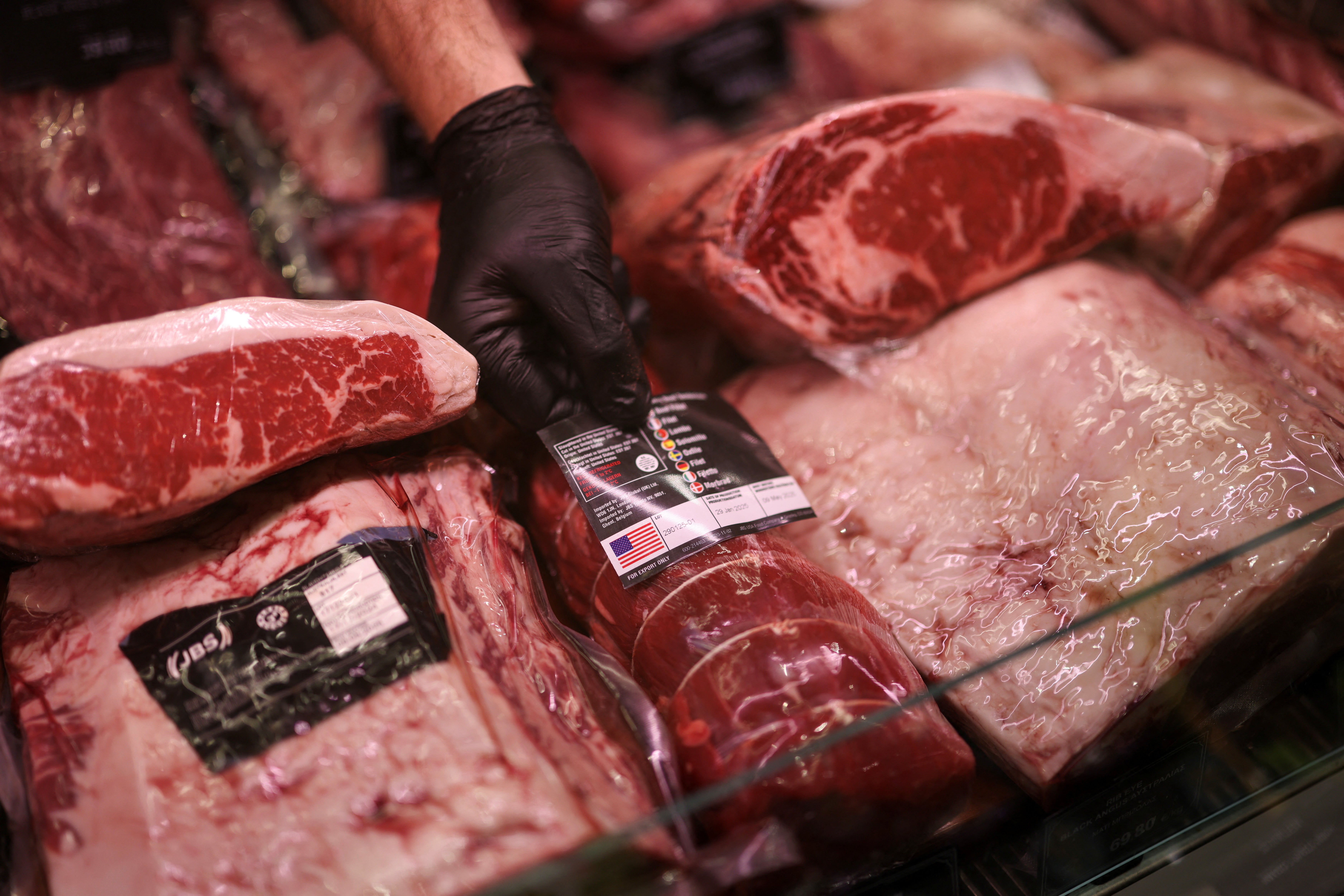 Representative. A butcher arranges meat