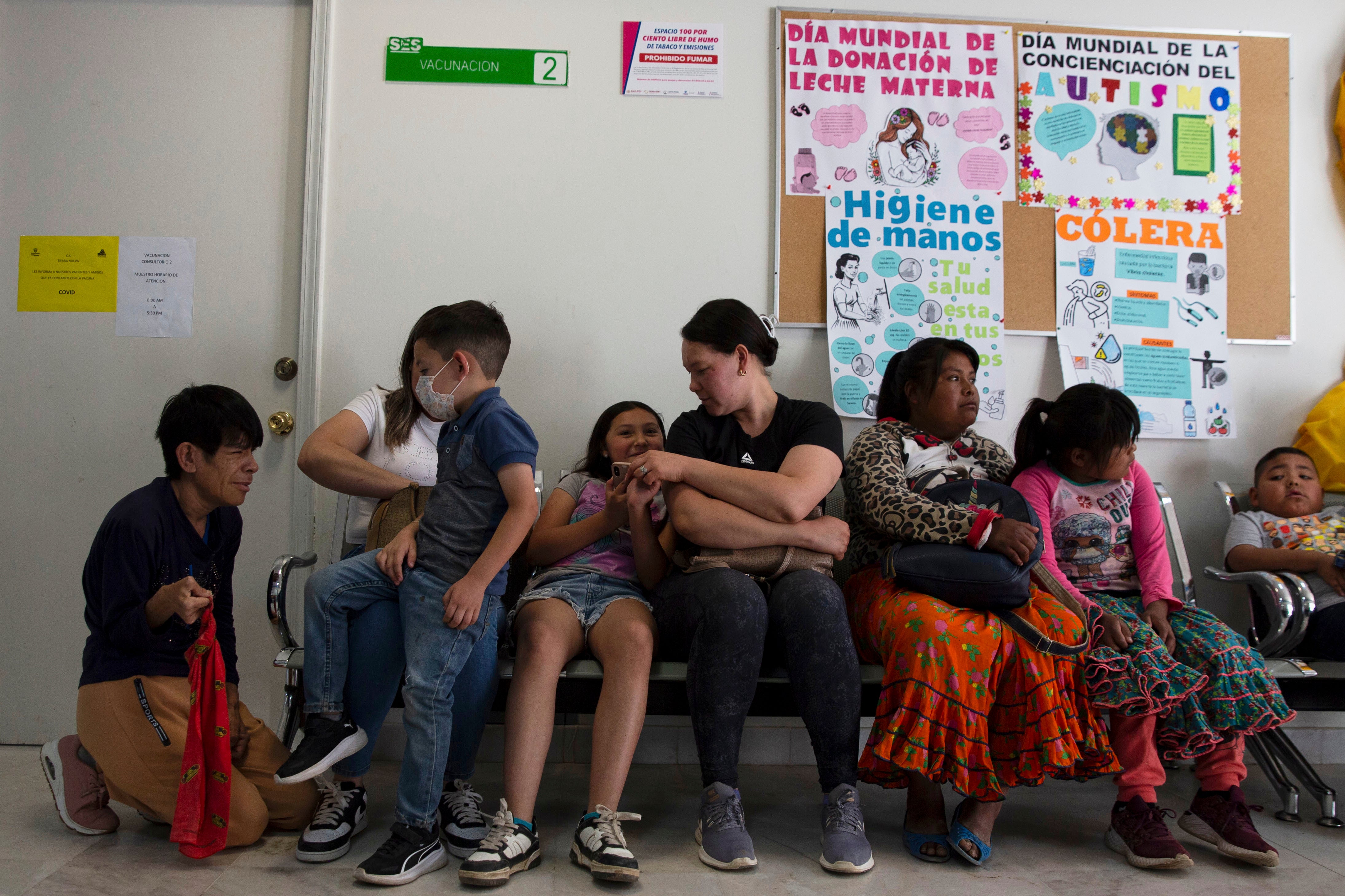 People wait to get vaccinated for measles at a health center in Cuauhtemoc, Chihuahua state, Mexico