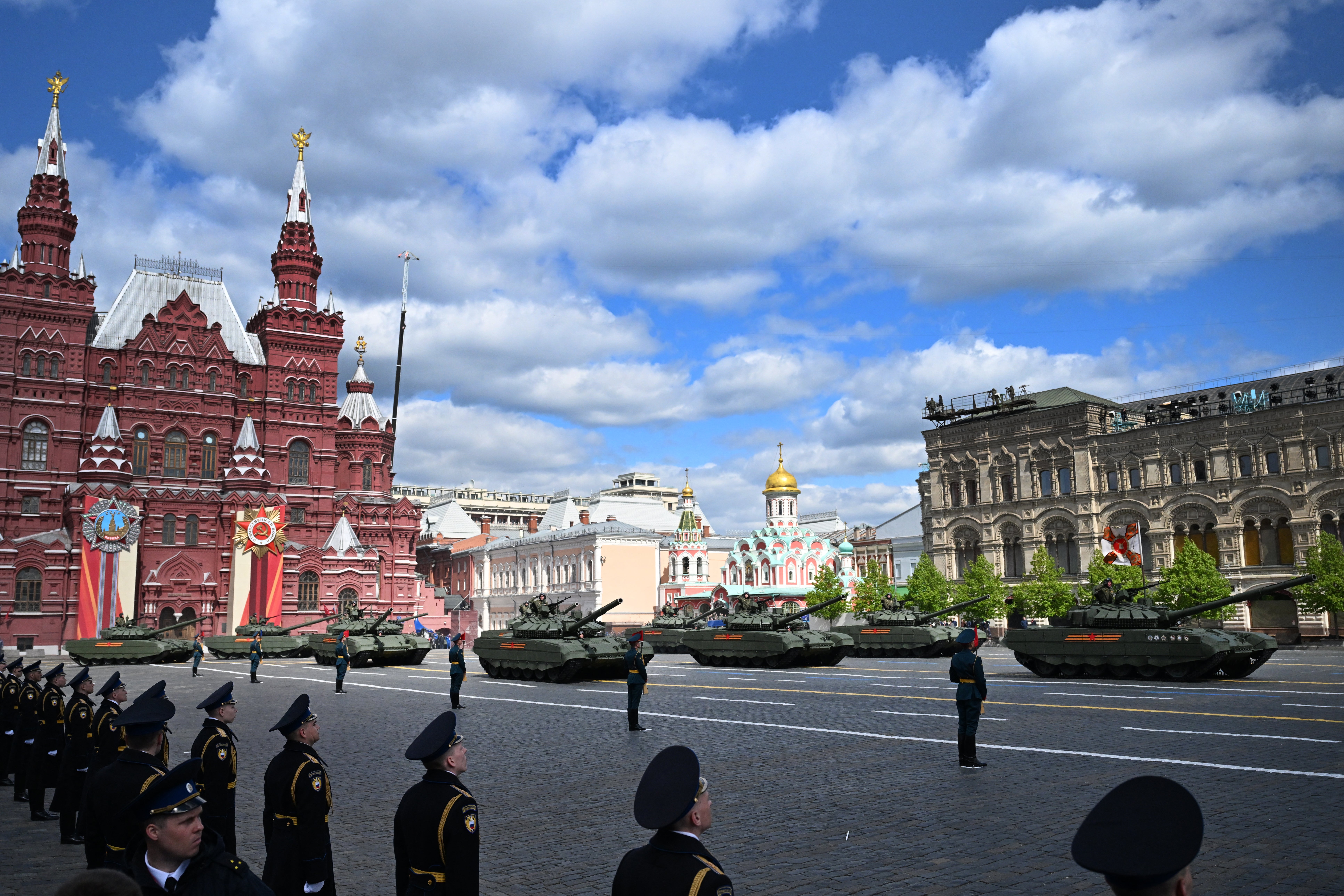A column of Russian T-72B3M tanks drives across Red Square on Friday morning