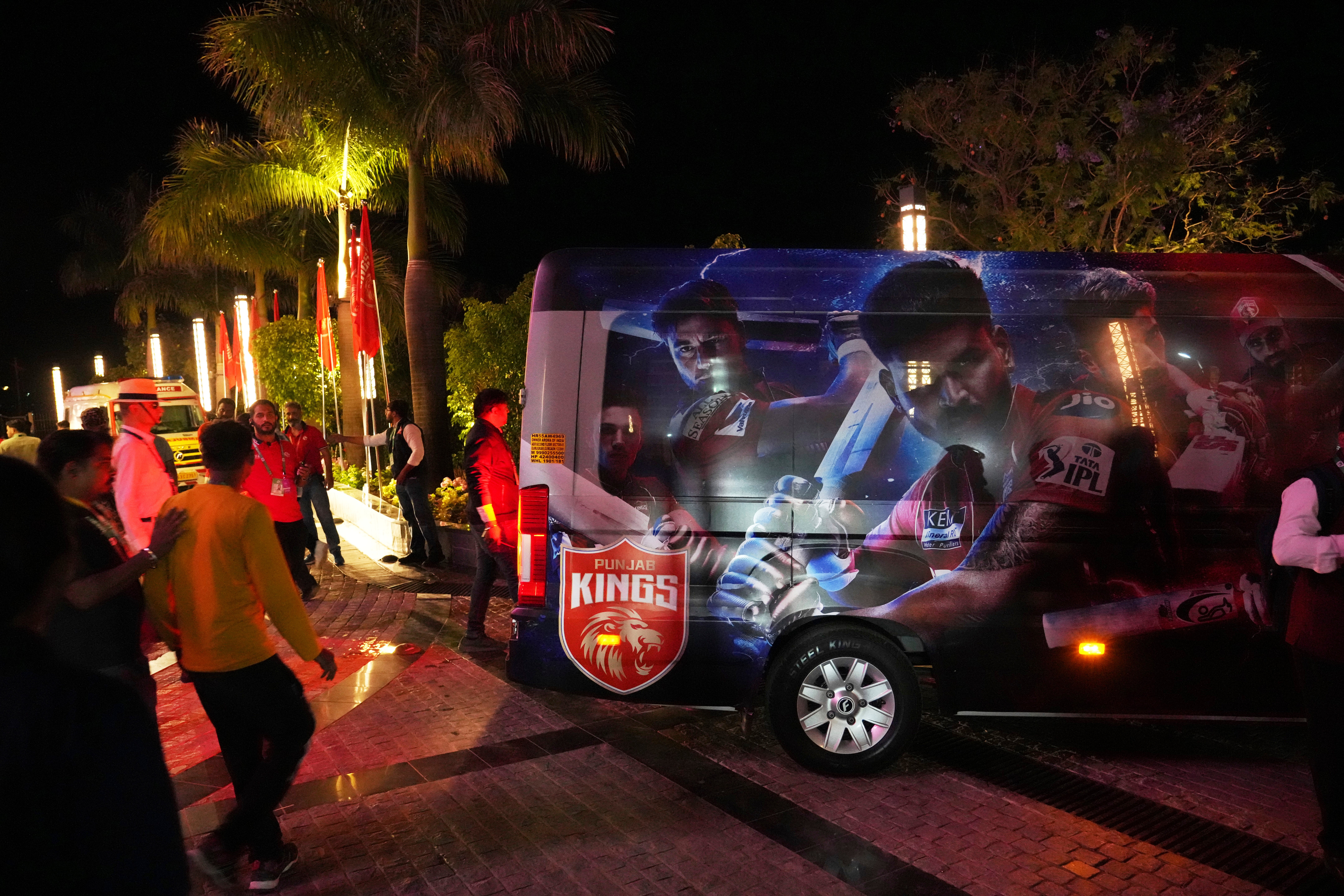 A vehicle waits to transport the players after the authorities asked to evacuate the stadium during the Indian Premier League cricket match between Punjab Kings and Delhi Capitals at Himachal Pradesh Cricket Association Stadium in Dharamshala, India