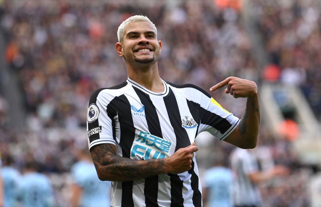 Bruno Guimaraes points to the Newcastle badge