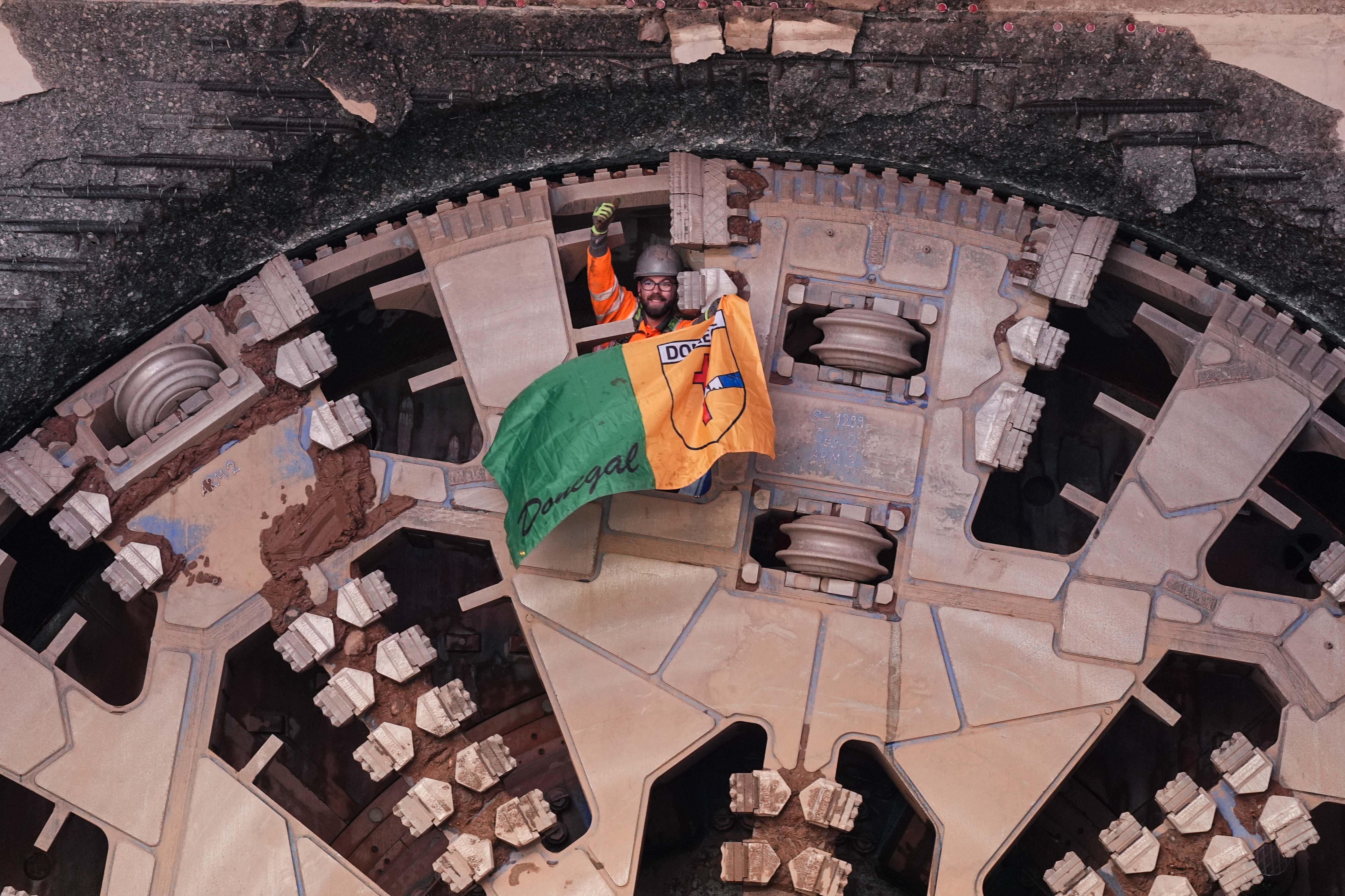 Pilots wave flags after boring machine Mary Ann broke through at Washwood Heath depot (Jacob King/PA)
