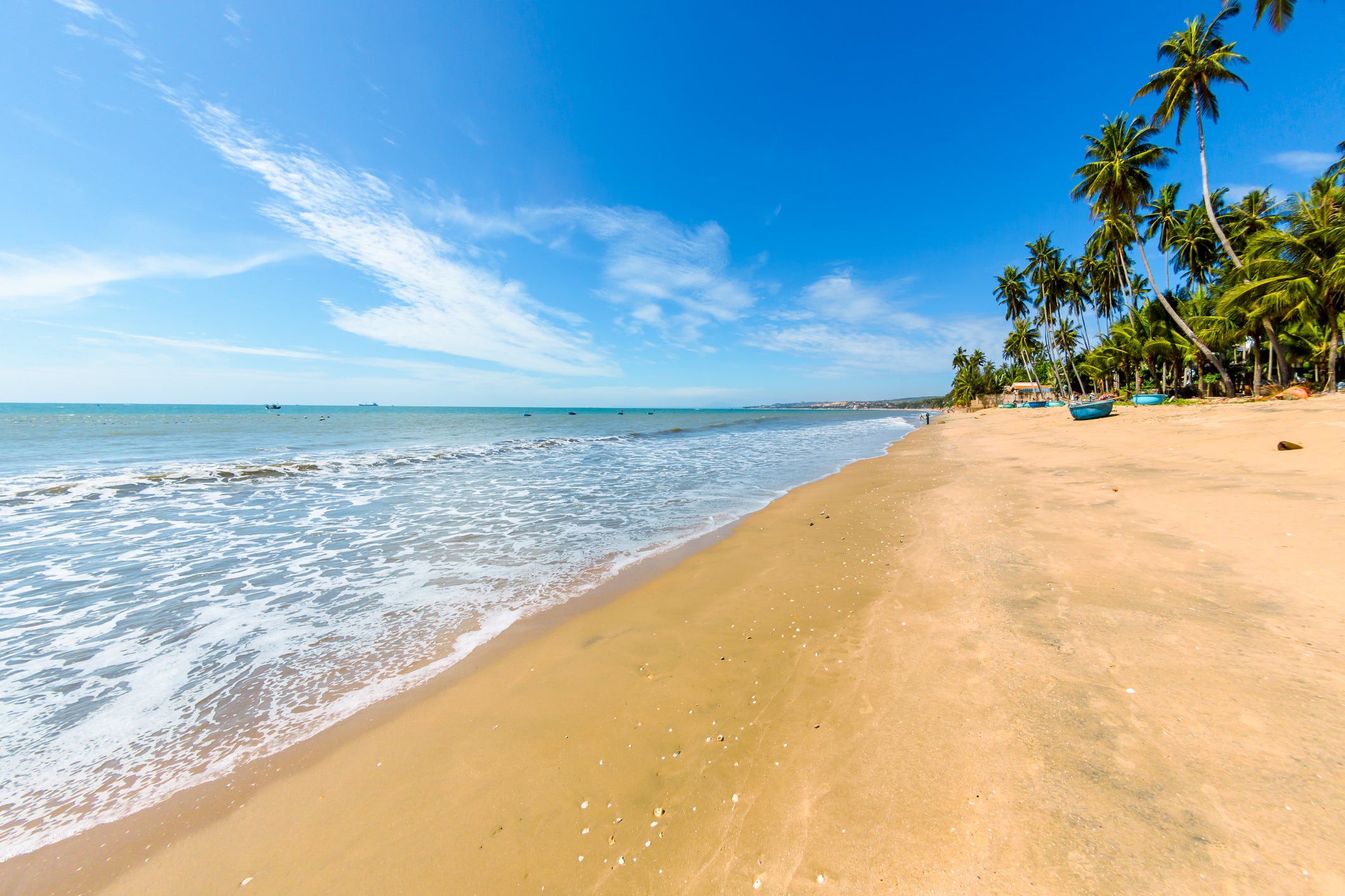 Mui Ne Beach in southern Vietnam is a golden sweep of soft sand backed by palm trees