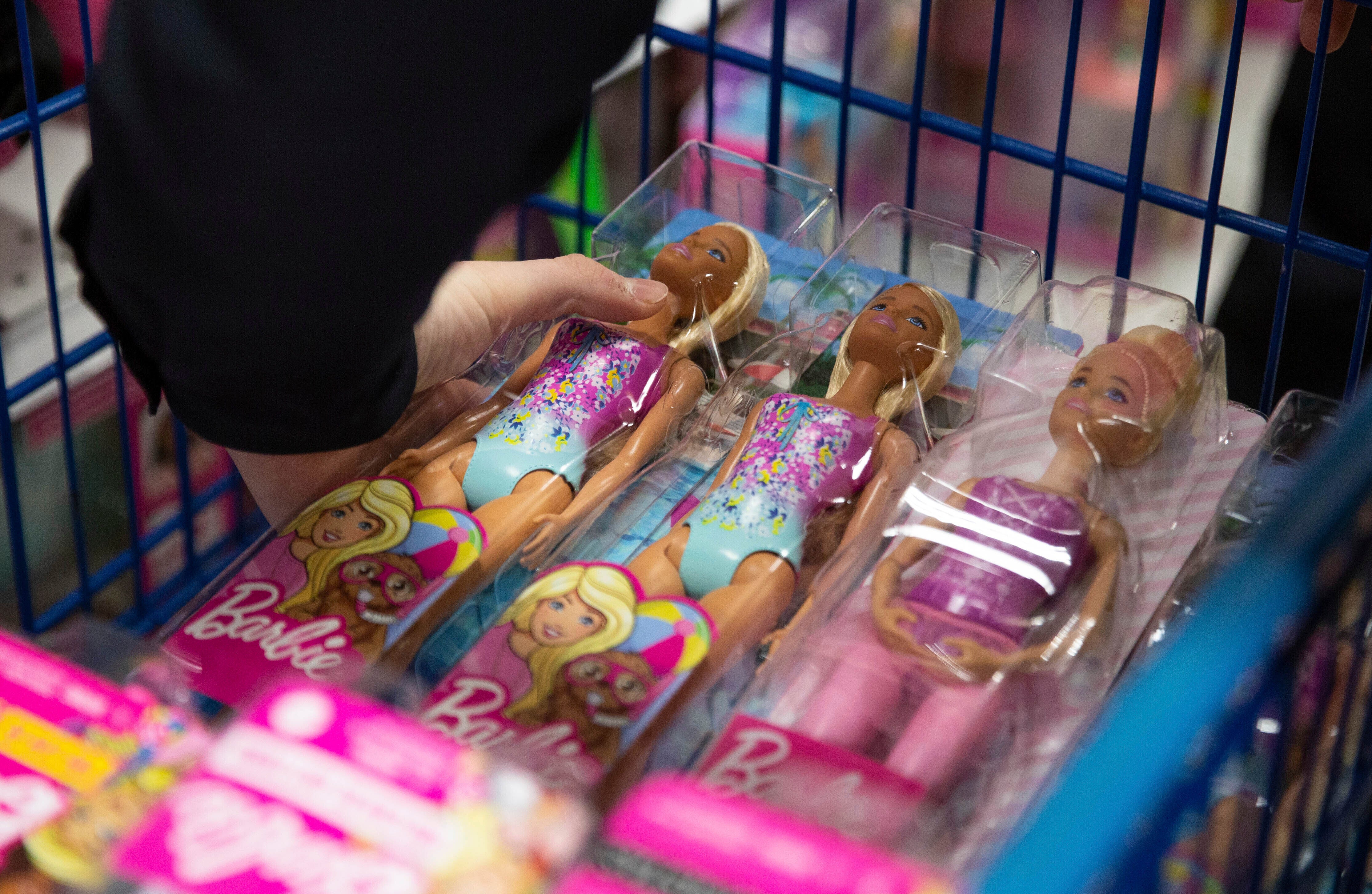 A collection of Barbie dolls are placed into a cart in Bowling Green, Ky., on Tuesday, Dec. 7, 2021. (Grace Ramey/Daily News via AP, File)