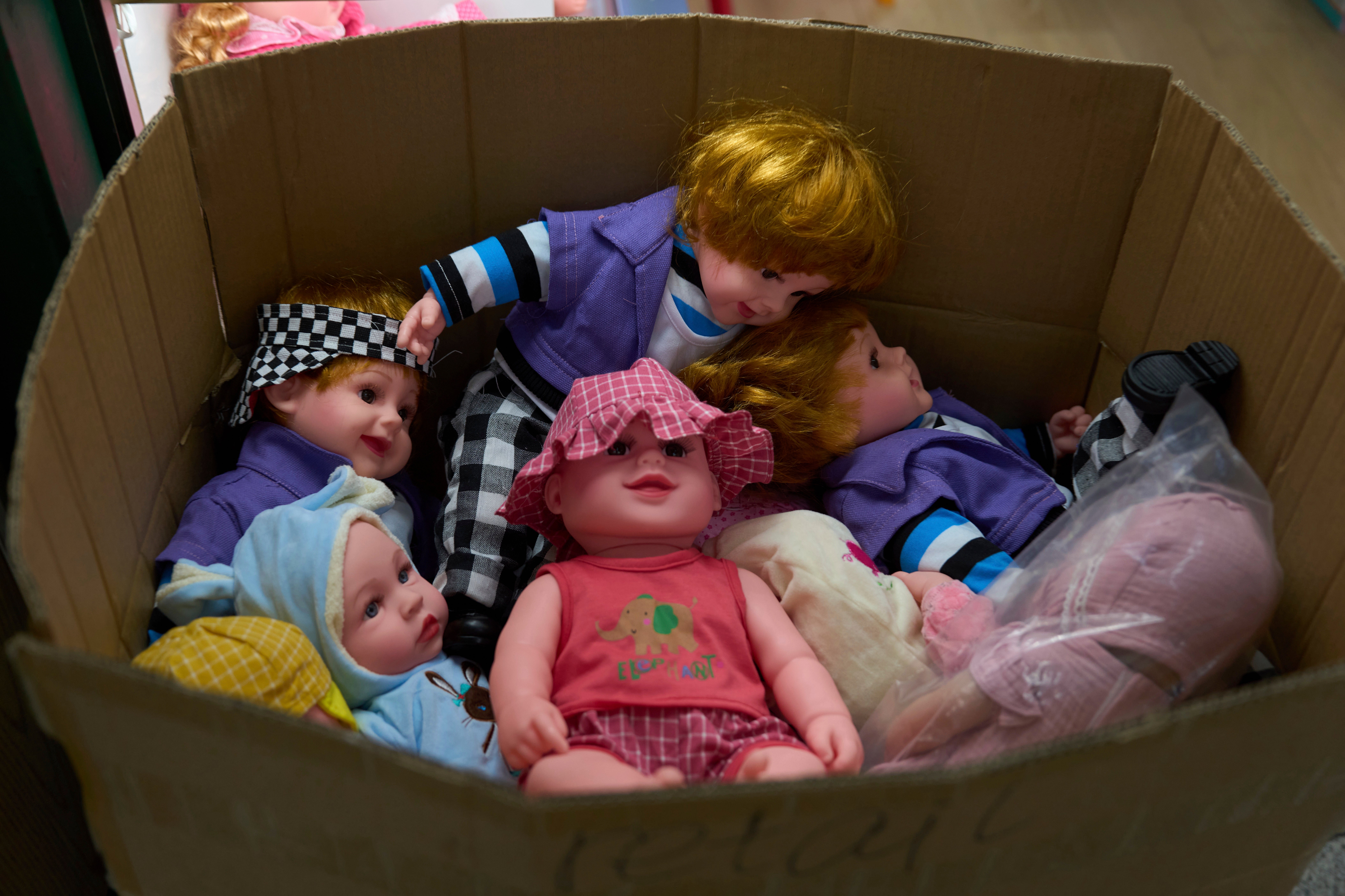 FILE -Dolls are packed in a carton at the Yiwu International Trade Market in Yiwu, eastern China's Zhejiang province