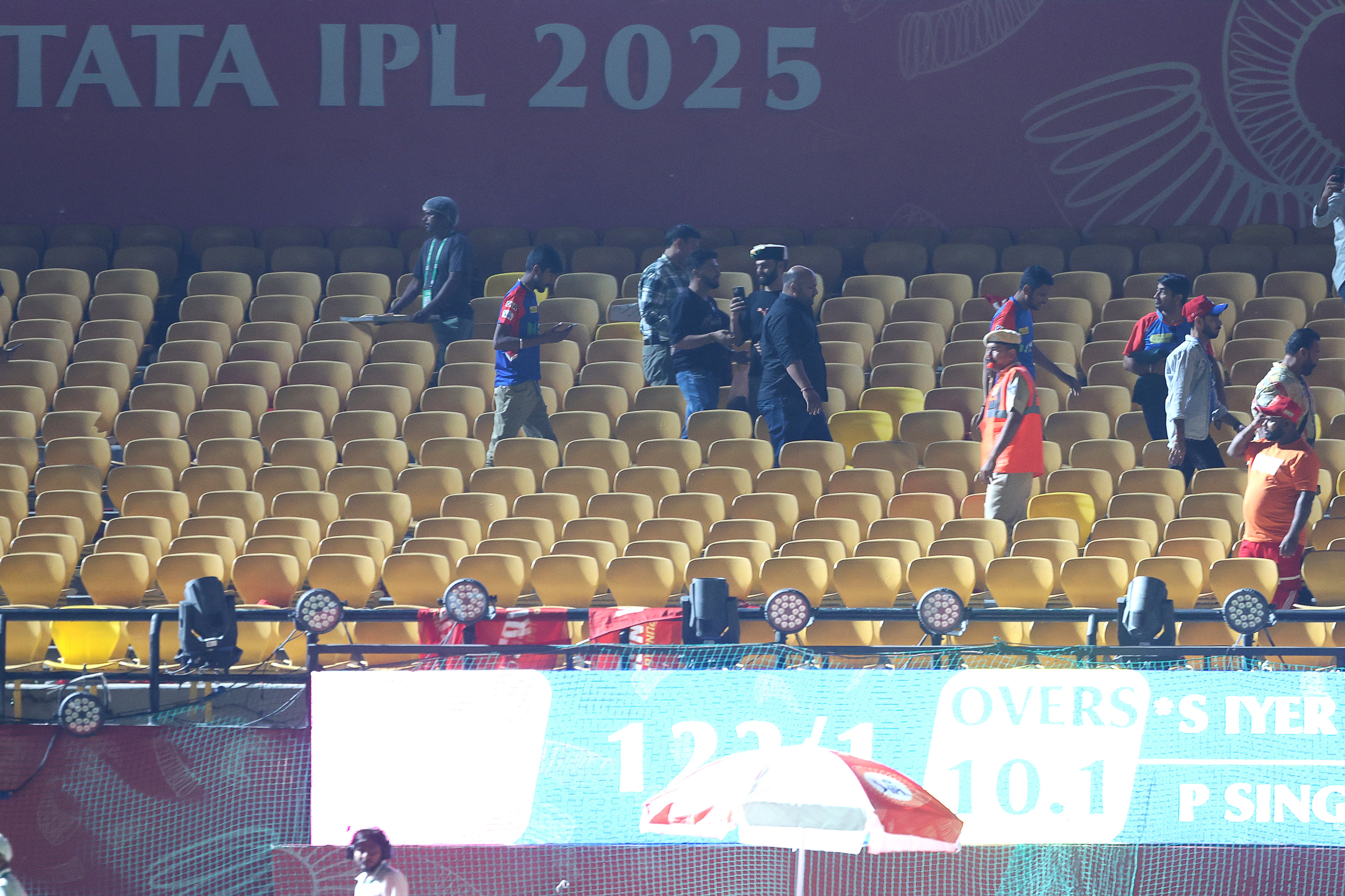 Spectators leave the stands after authorities evacuated the stadium during the 2025 IPL match between Punjab Kings and Delhi Capitals